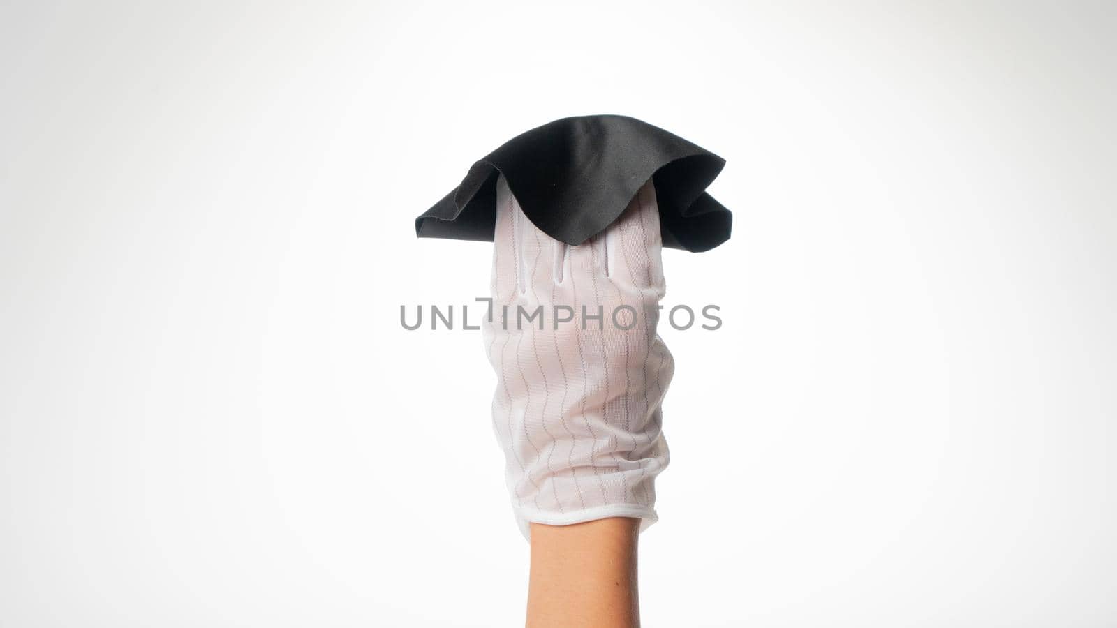 Hand in a white hygienic glove with a cloth for wiping monitors by voktybre