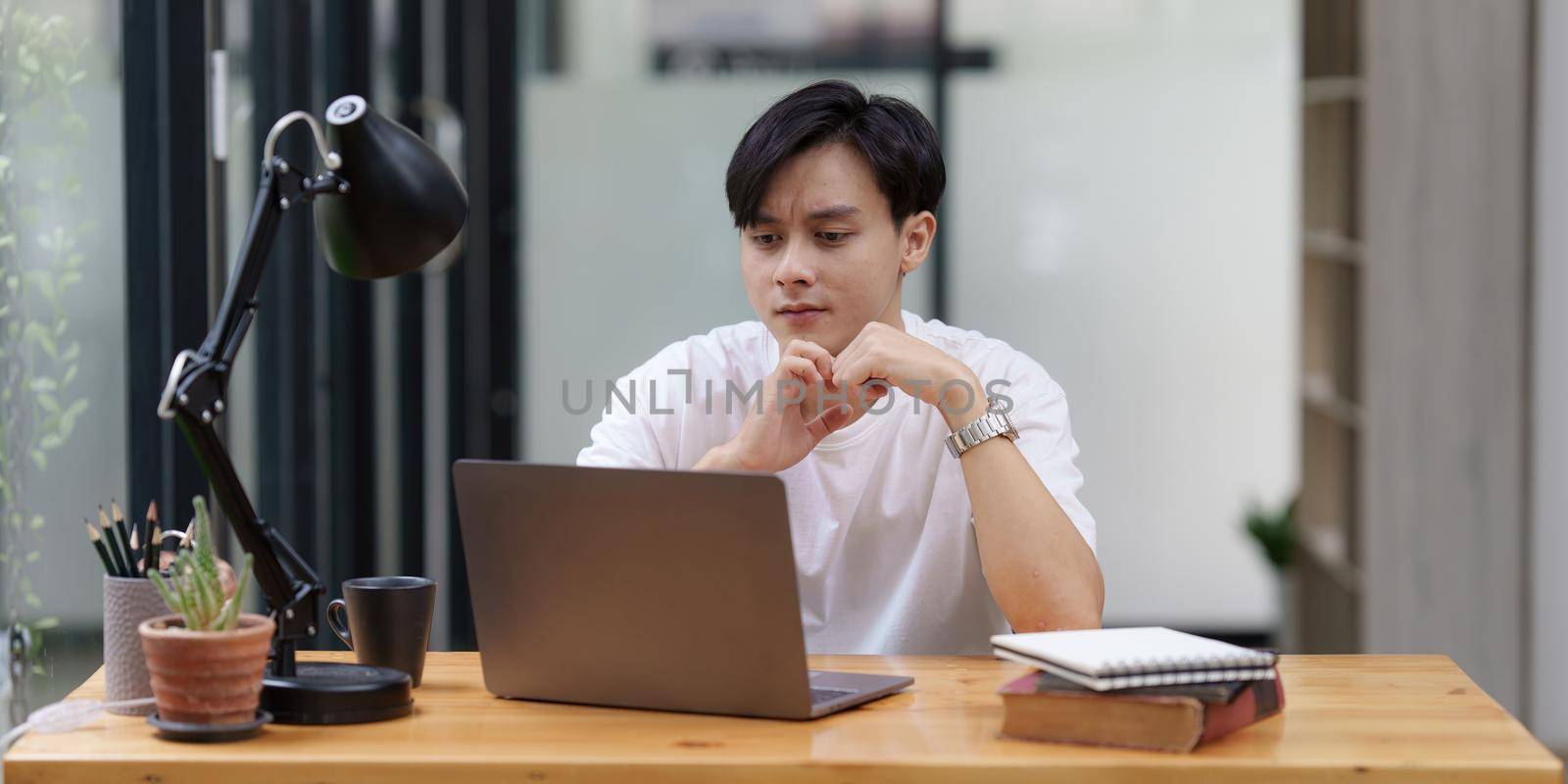 Asian man have video call meeting with partner by laptop computer by itchaznong