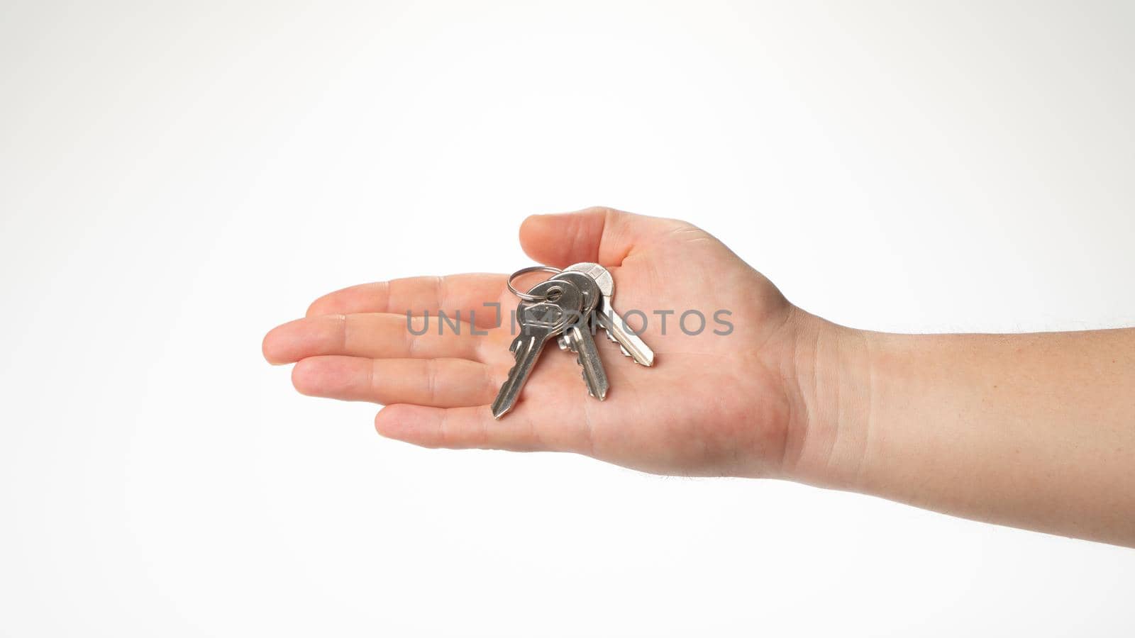 A bunch of keys lies on a man's right palm gesture by voktybre