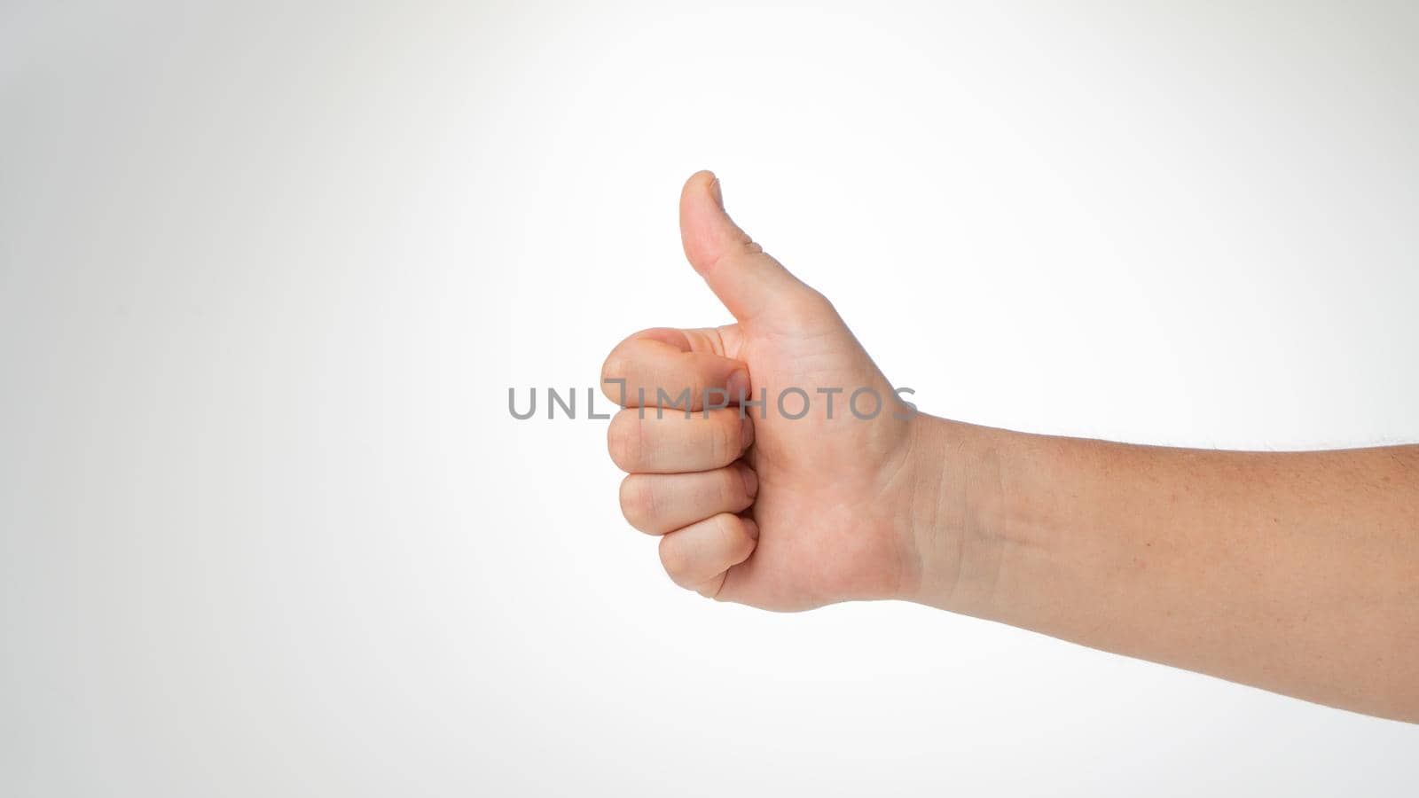 Men's hand thumbs up gesture like, cool. High quality photo