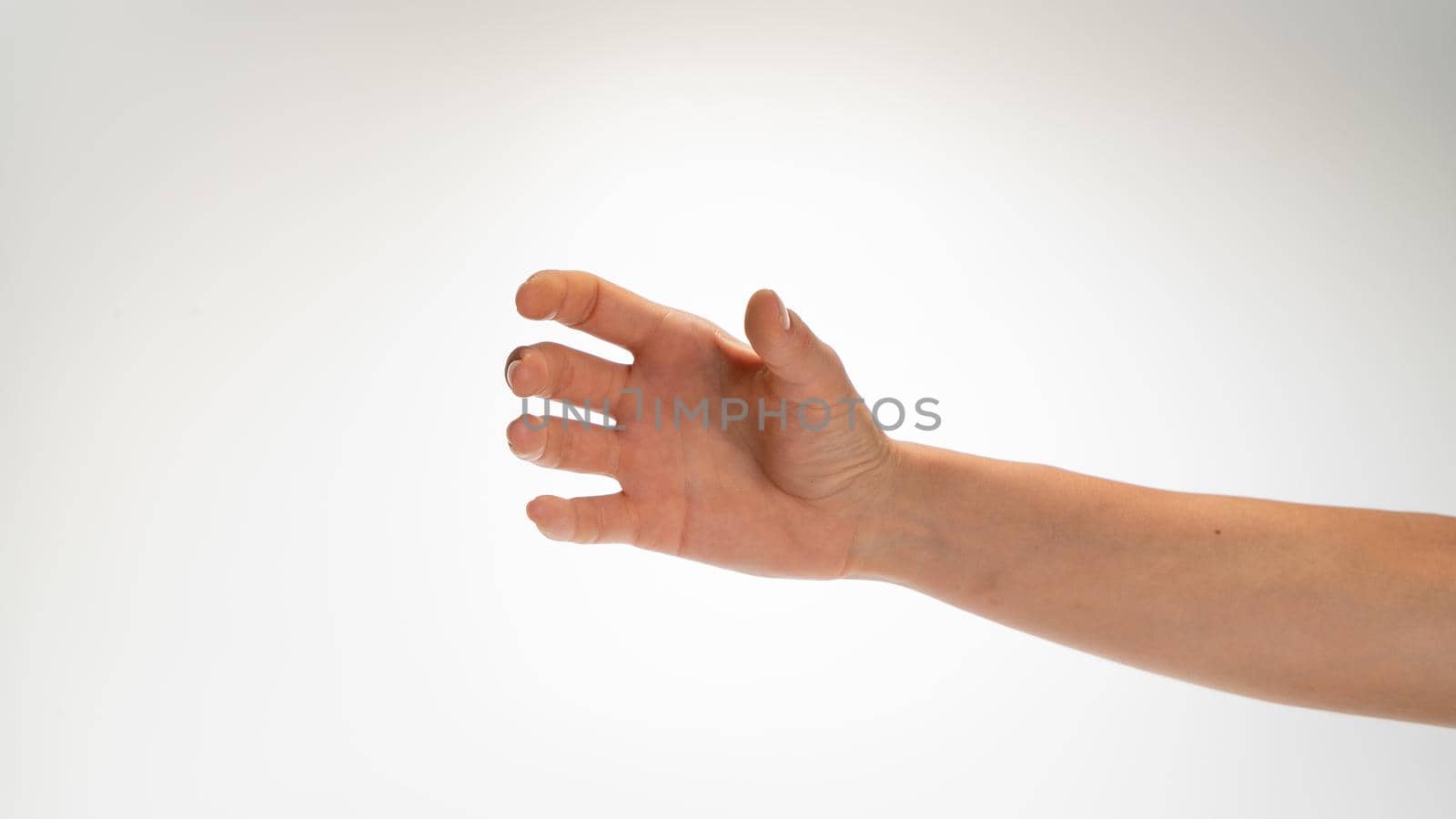 Hand woman gesture place under glass bottle cylinder on white background. High quality photo