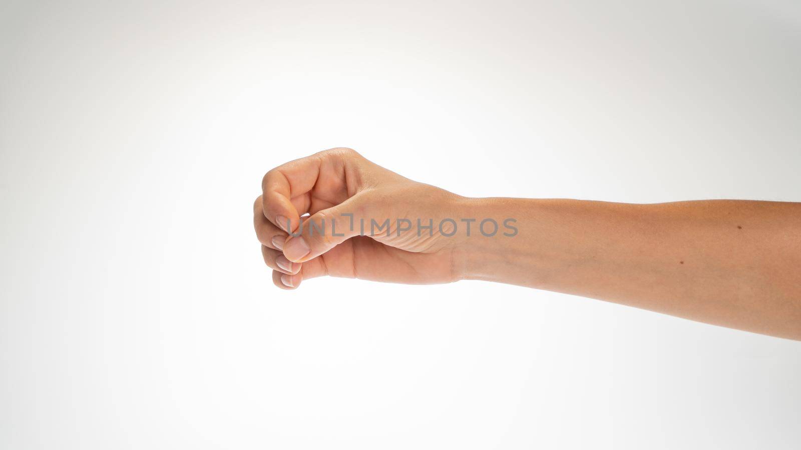 Hand woman gesture fingers clenched into a ring holding a cylindrical object. High quality photo