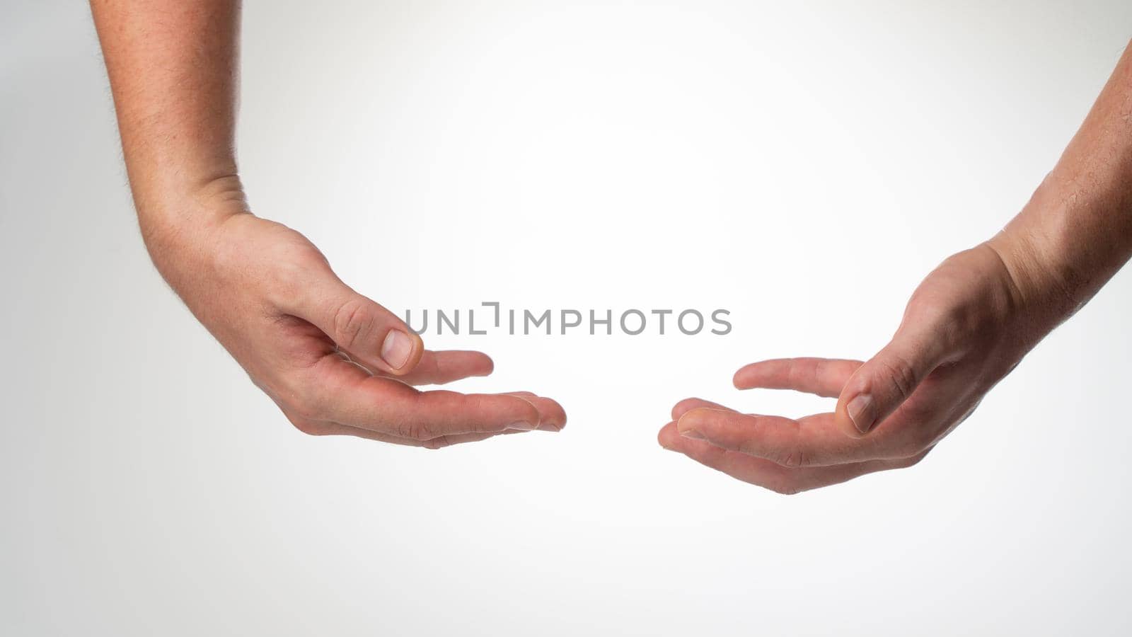 Men's insulated hands hold a heavy object on a white background by voktybre