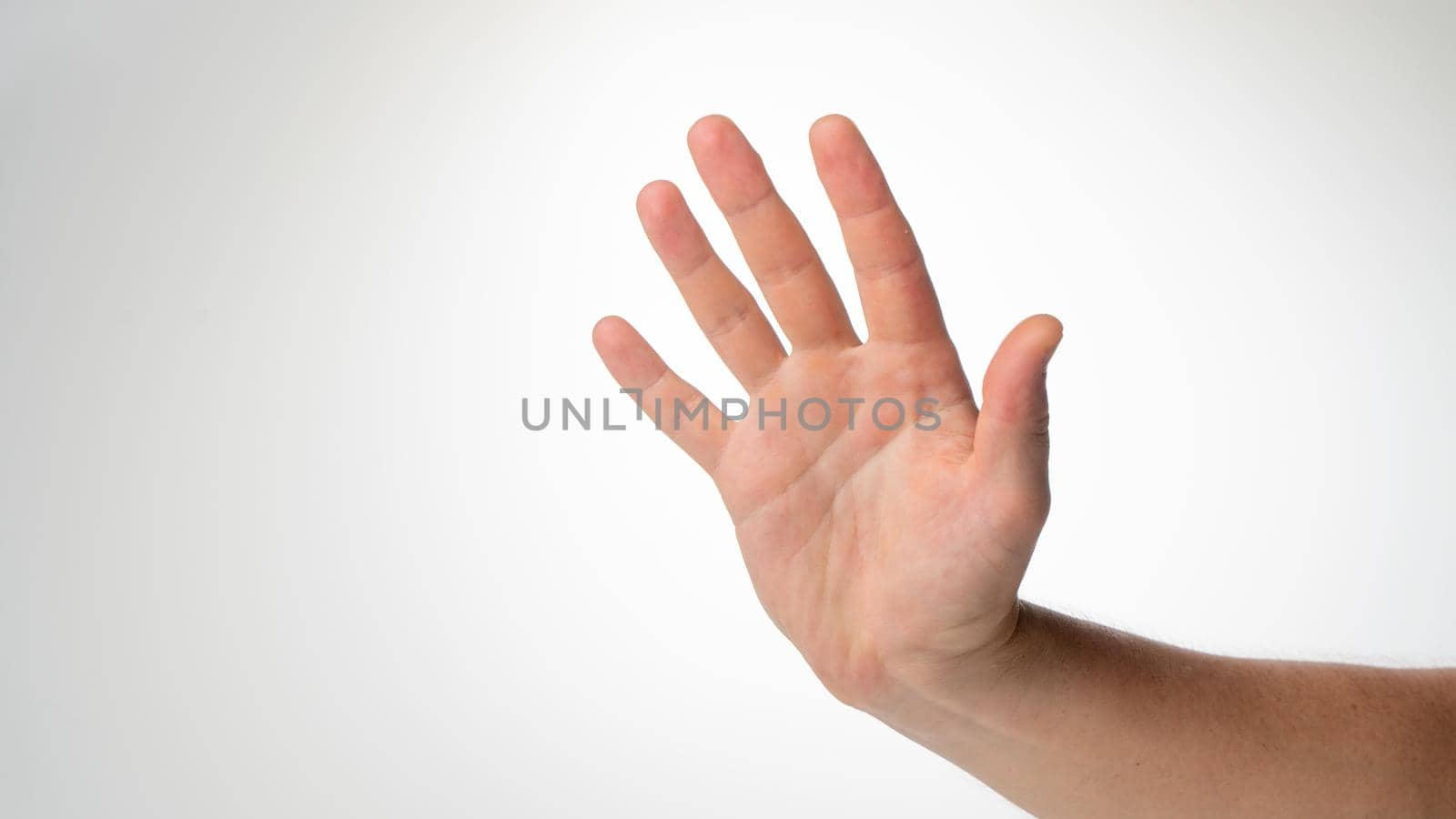 Men's hand gesture stop on a white background. High quality photo