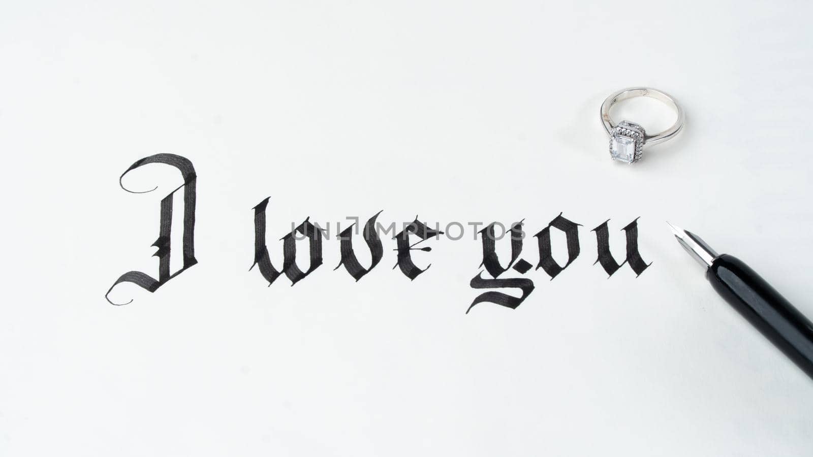 Calligraphy writing font phrase I love you composition with ring and feather pen by voktybre