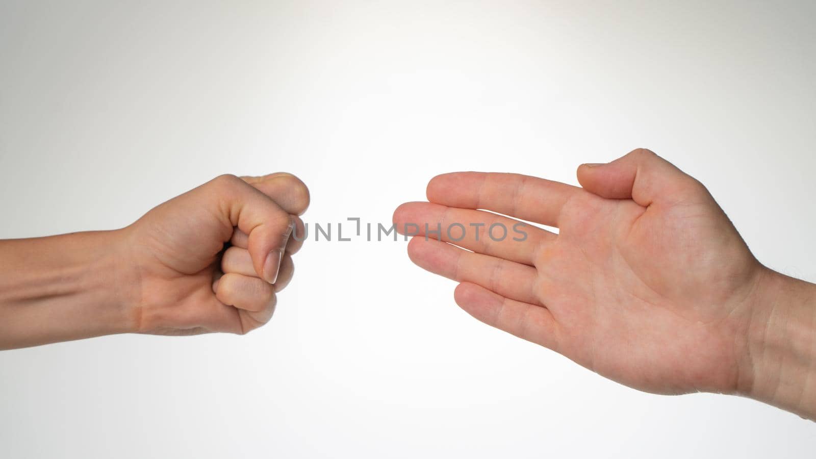 Hands close-up gesture from the game rock paper scissors. High quality photo