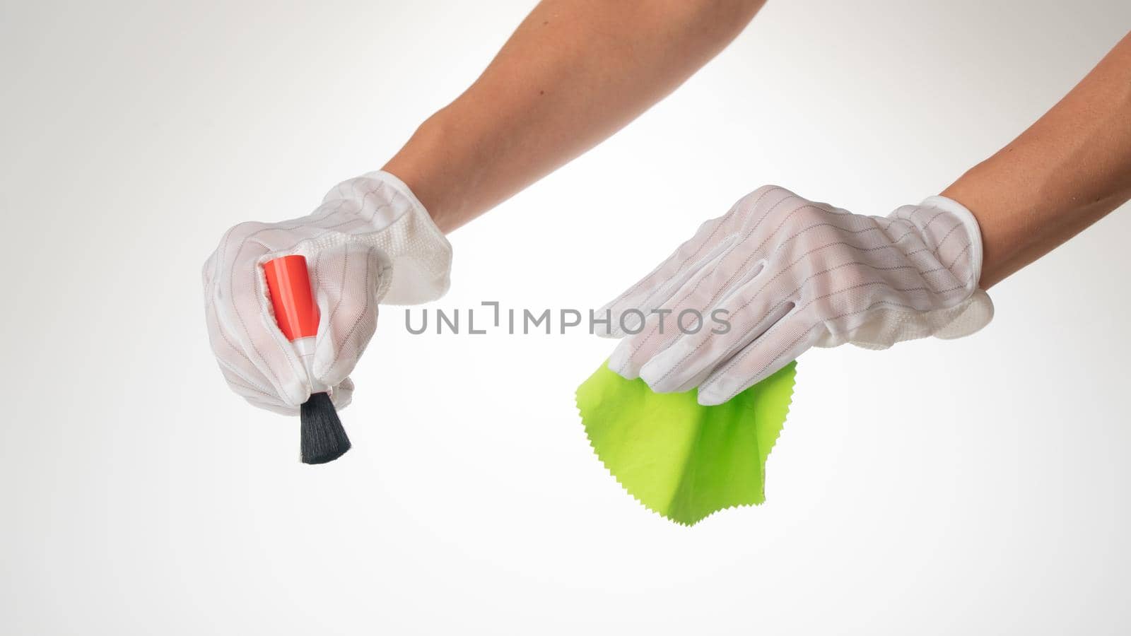 Hand gesture on a white background wearing protective gloves with a screen wipe cloth and dust brush by voktybre