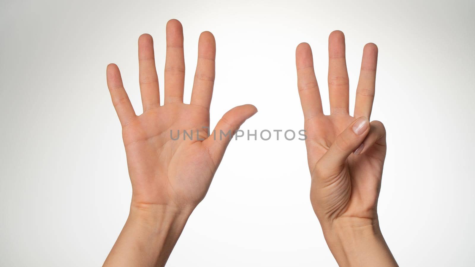 Women's hands gesture counting on fingers 8 palm side. High quality photo