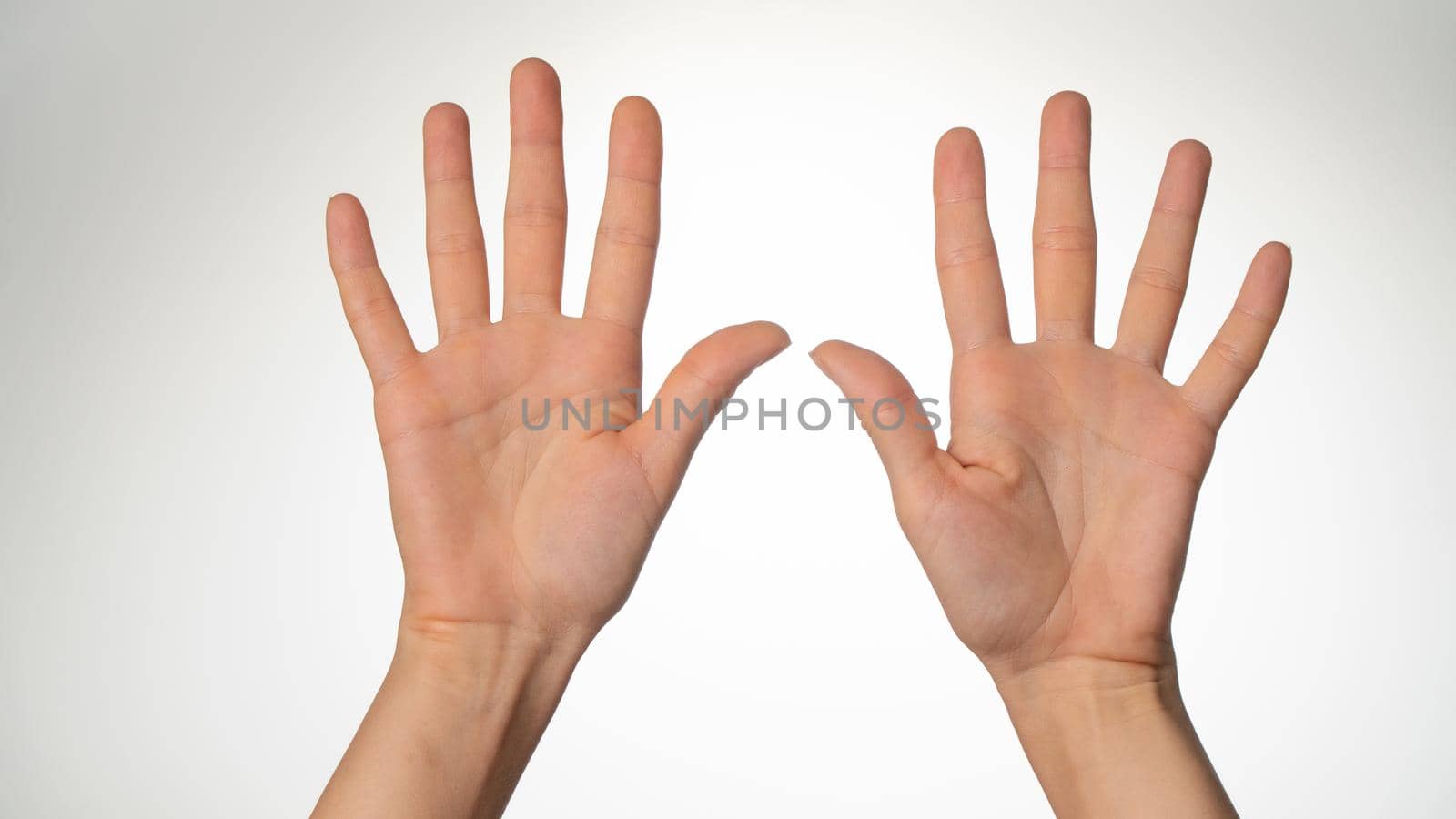 Women's hands gesture counting on fingers 10 palm side. High quality photo