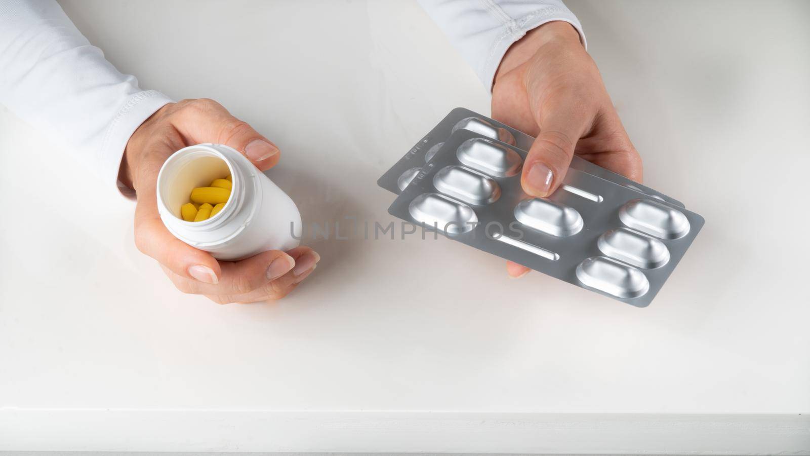 Tablets, pills and vitamins in the hands on a white background - medicine, doctor. High quality photo