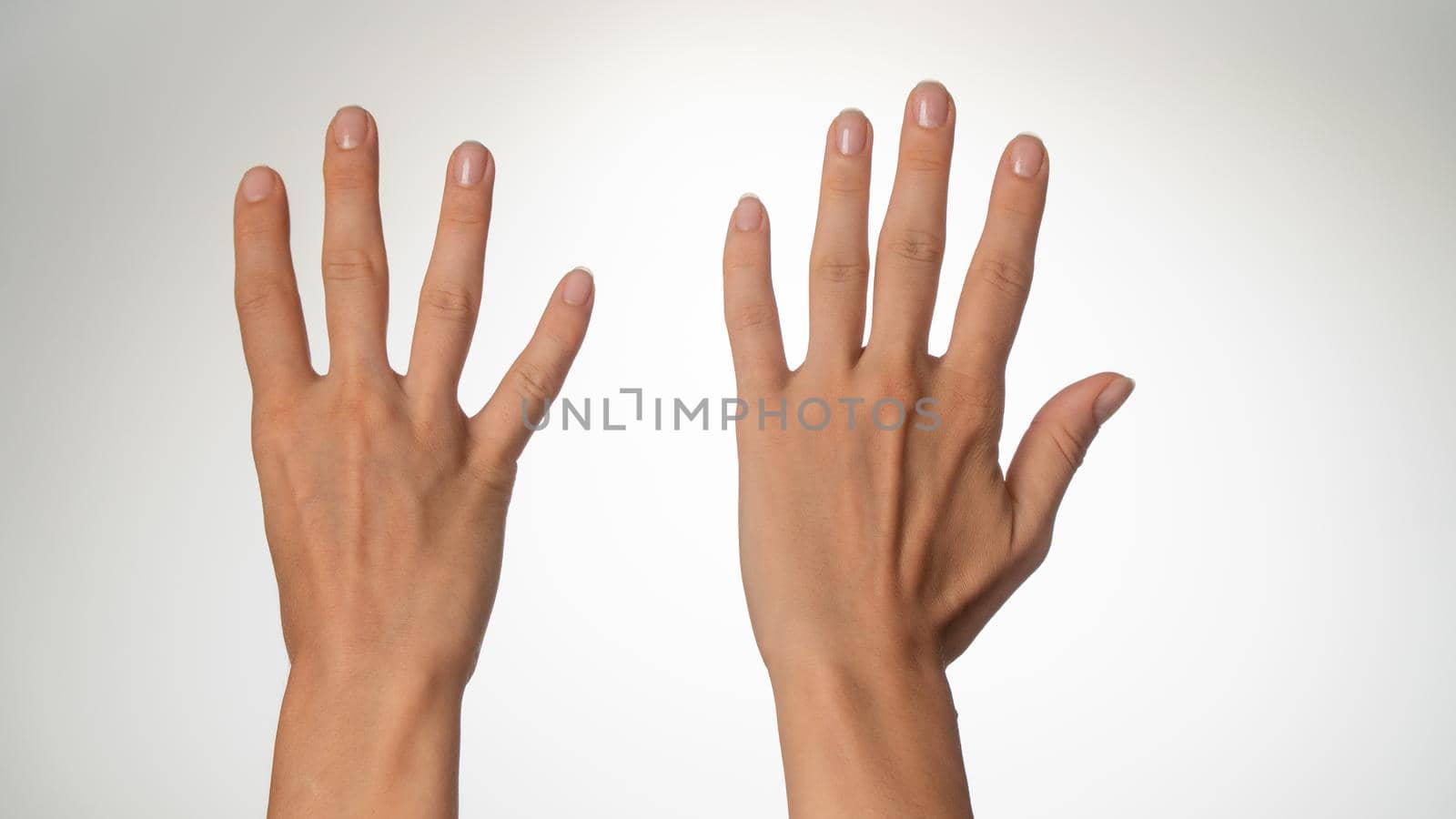 Women's hands count on fingers nine back of palms by voktybre