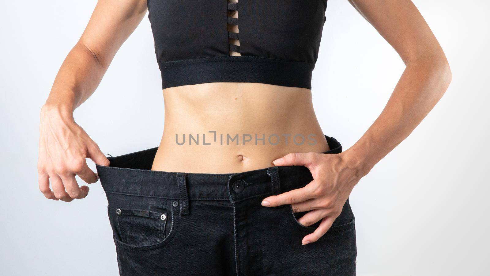 A woman in pants a size larger - weight loss, slim body, after dieting. High quality photo