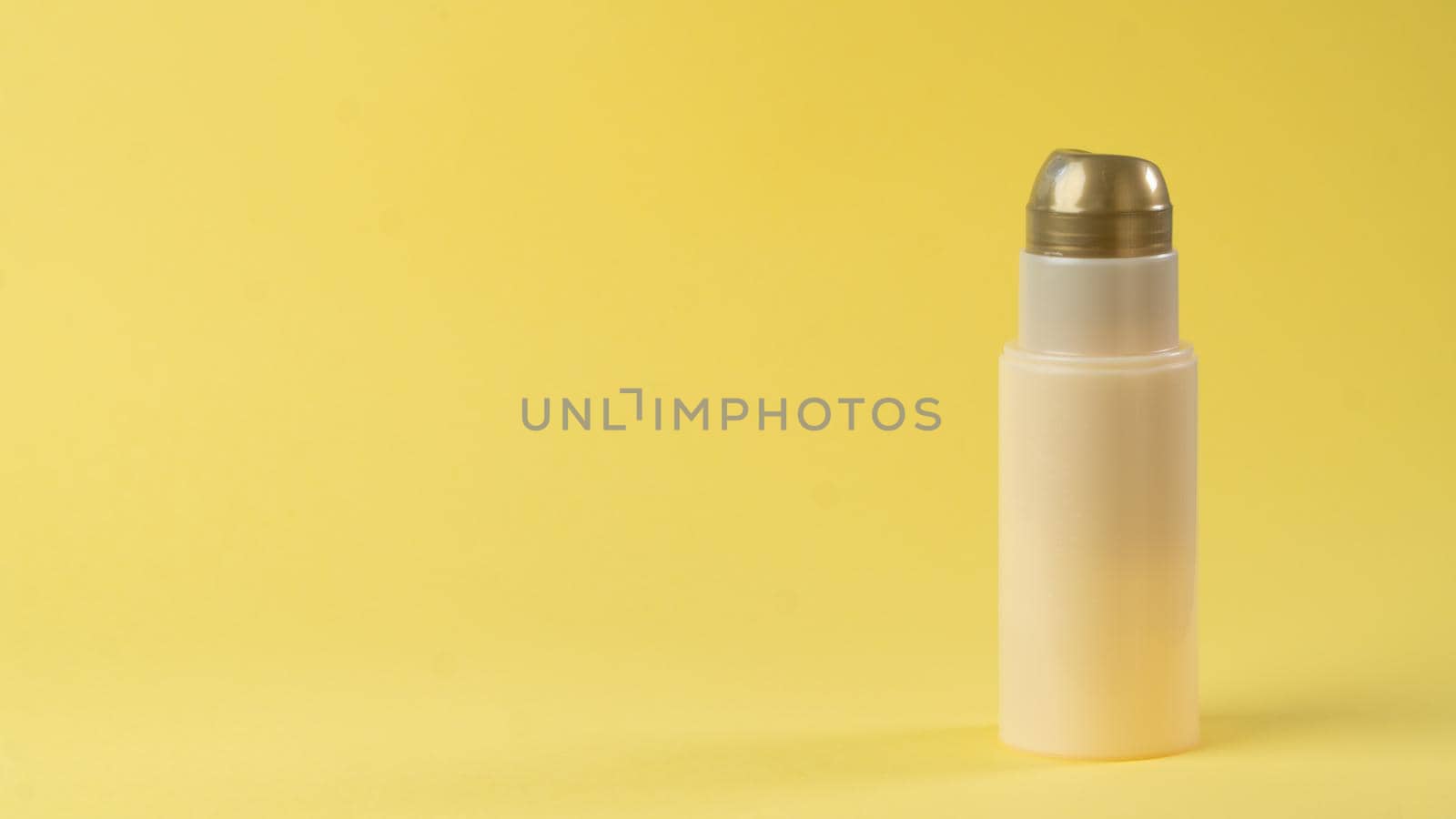 Tube to cream spray on a yellow background, place for text and label. High quality photo