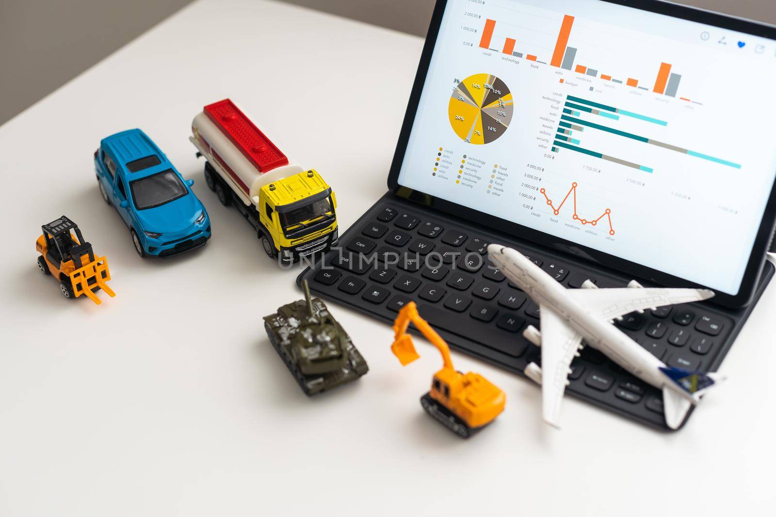 a set of toy vehicles and a tablet by Andelov13