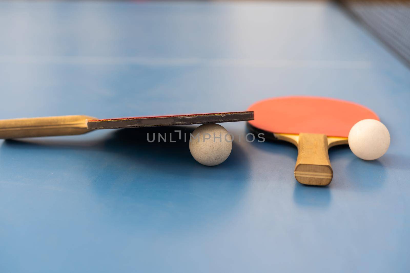 Ping pong table, rackets and balls in a sport hall.