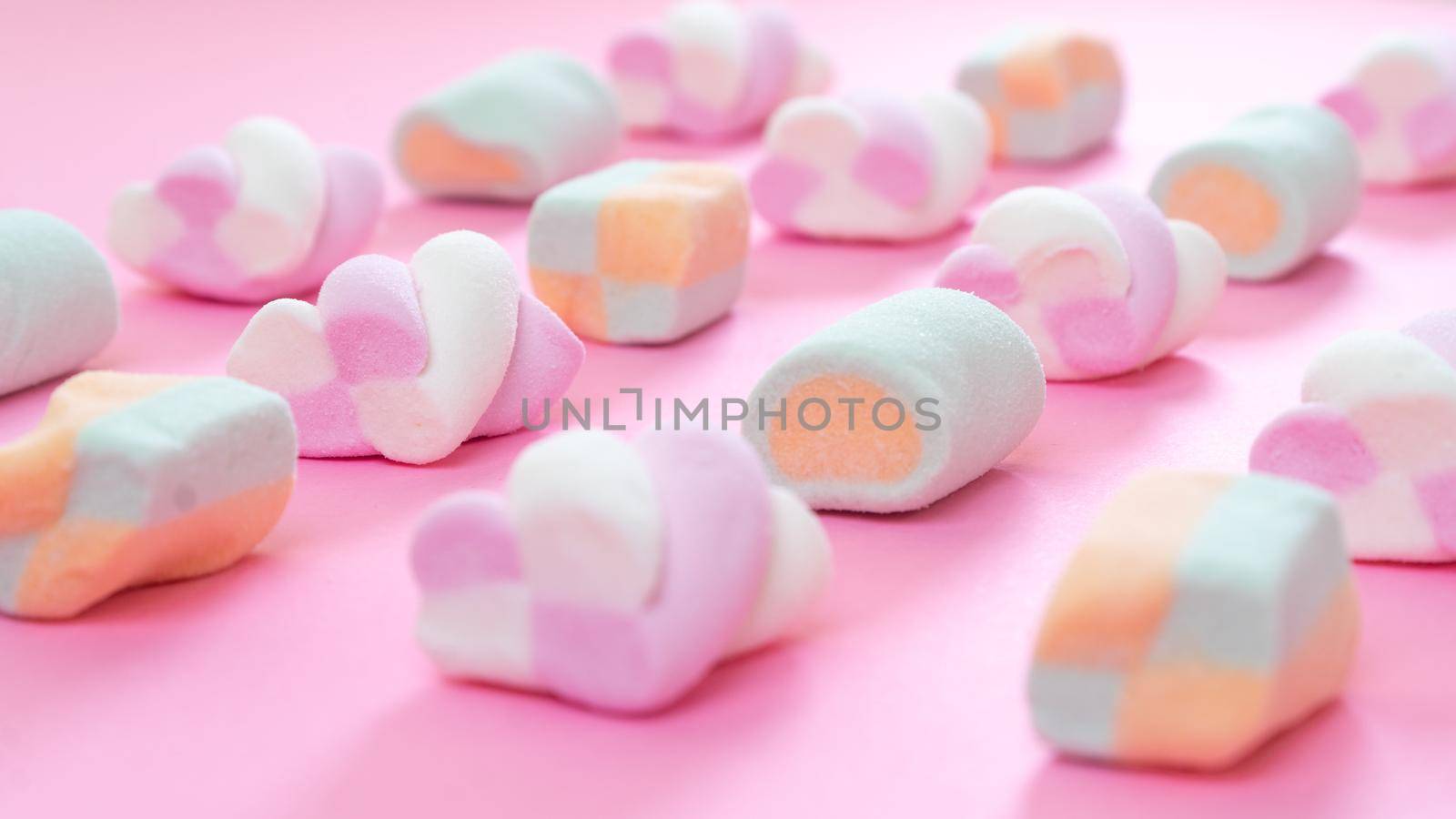 Close-up of marshmallows on a pink background, delicate color of sweets by voktybre