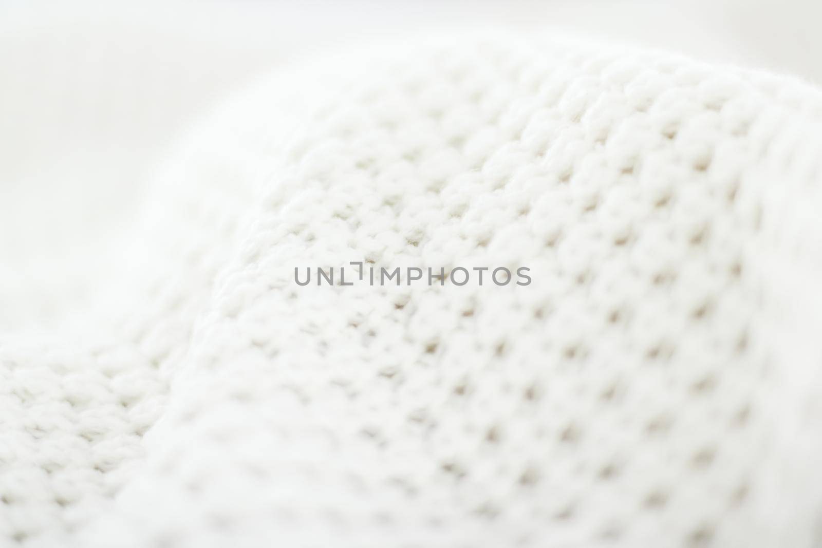 Knitwear, fabric textures and handmade items concept - Warm knitted clothes, soft and white