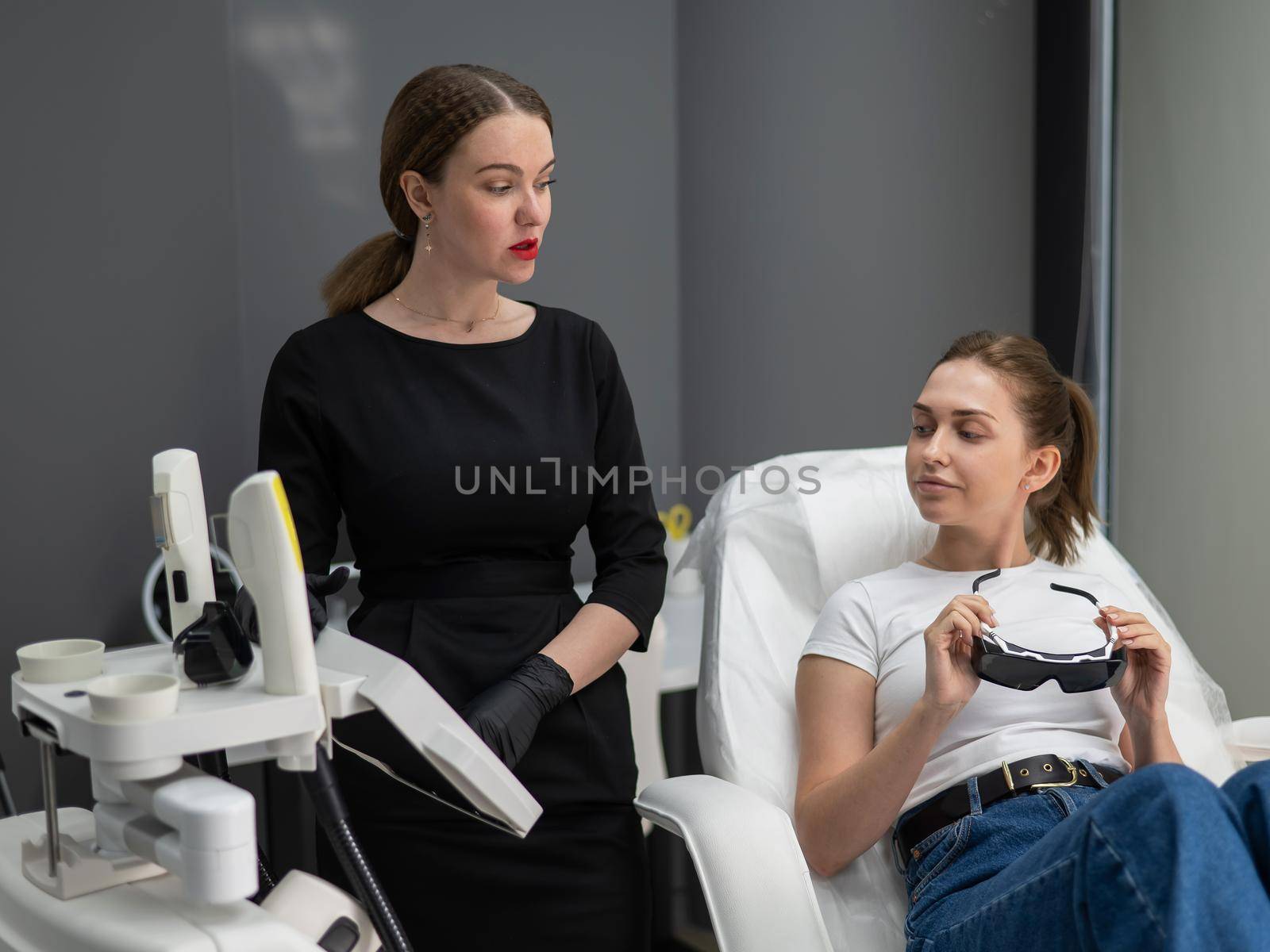 Young caucasian woman on photorejuvenation procedure. Portrait of a girl in a beautician's clinic
