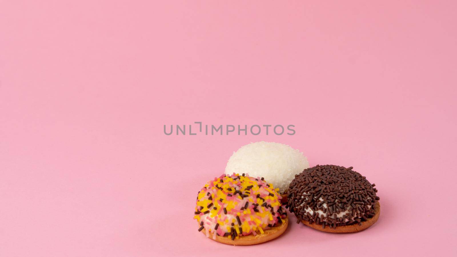 Cupcakes with confectionery decor on a pink background - sweets by voktybre