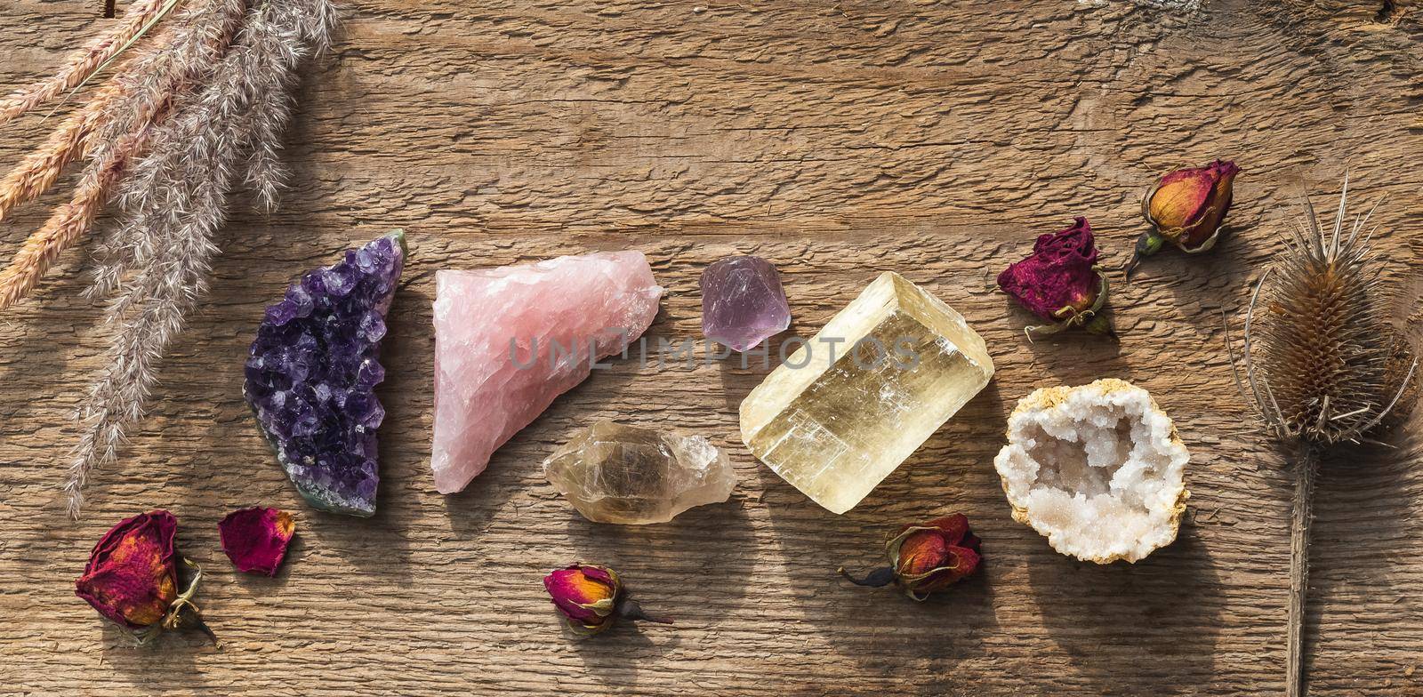 Colorful healing crystals and minerals in a row by Syvanych