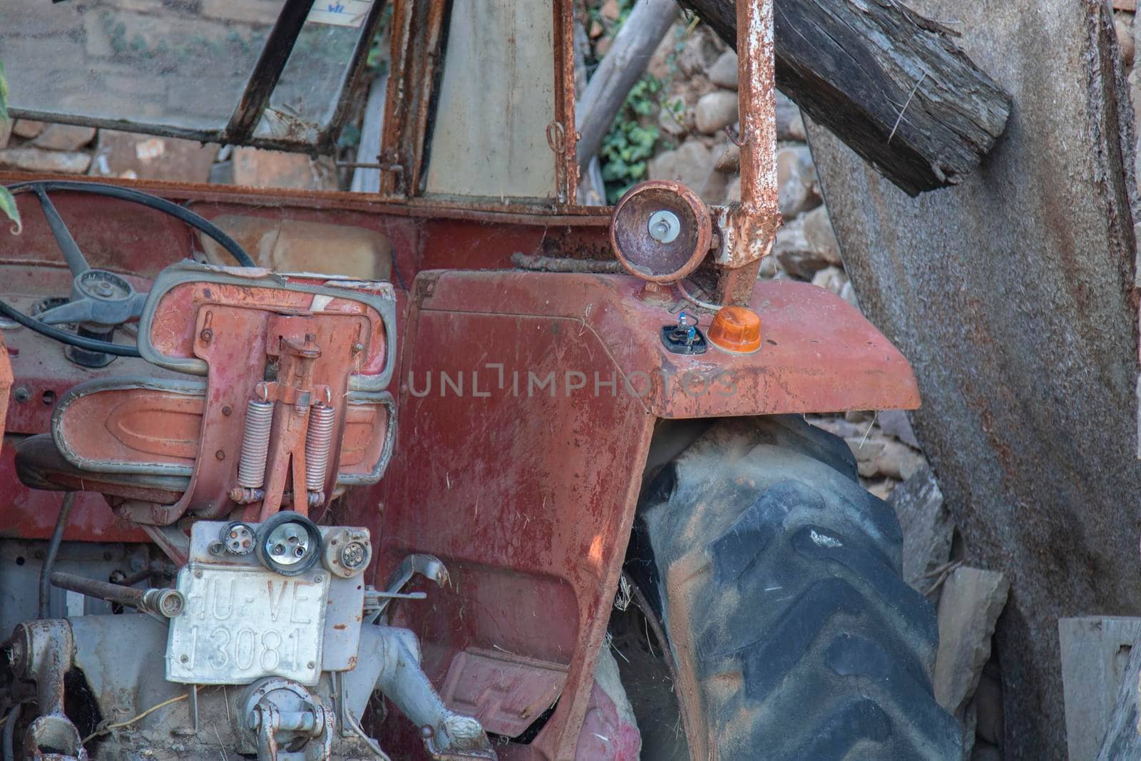 Red decay old tractor abandoned in the countryside