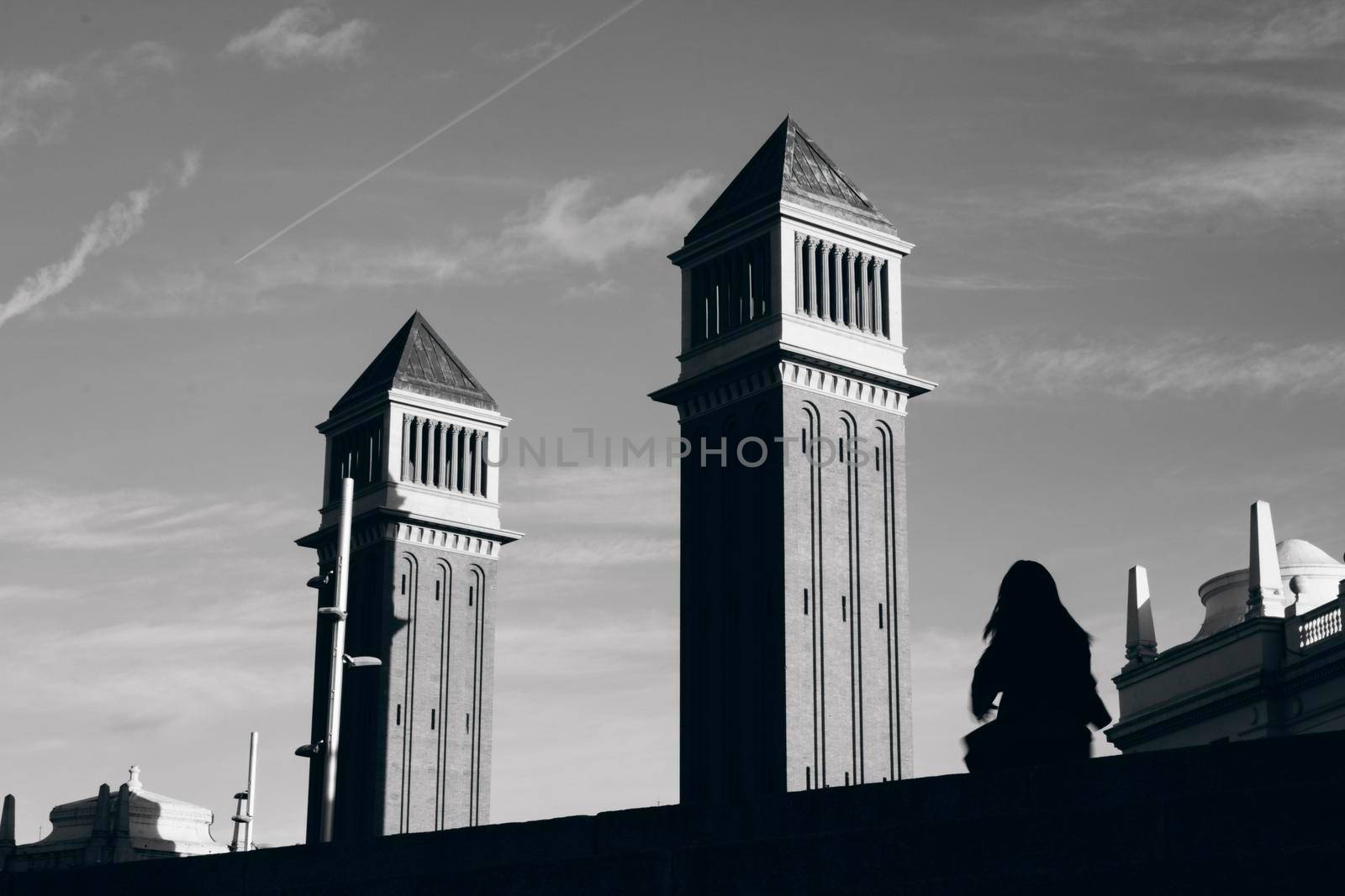 Two towers in Spain square in Barcelona and a little girl's silhouette dancing