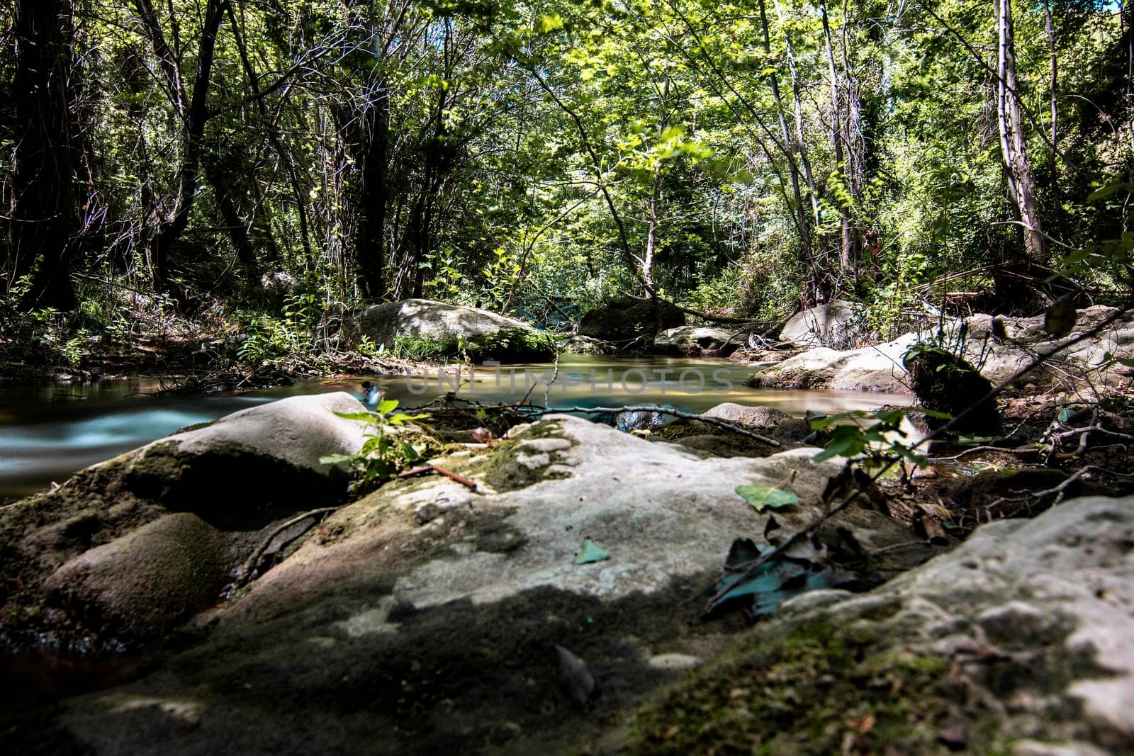 Wild rocky river in the forest long exposure picture in Riells del Fai in Catalonia