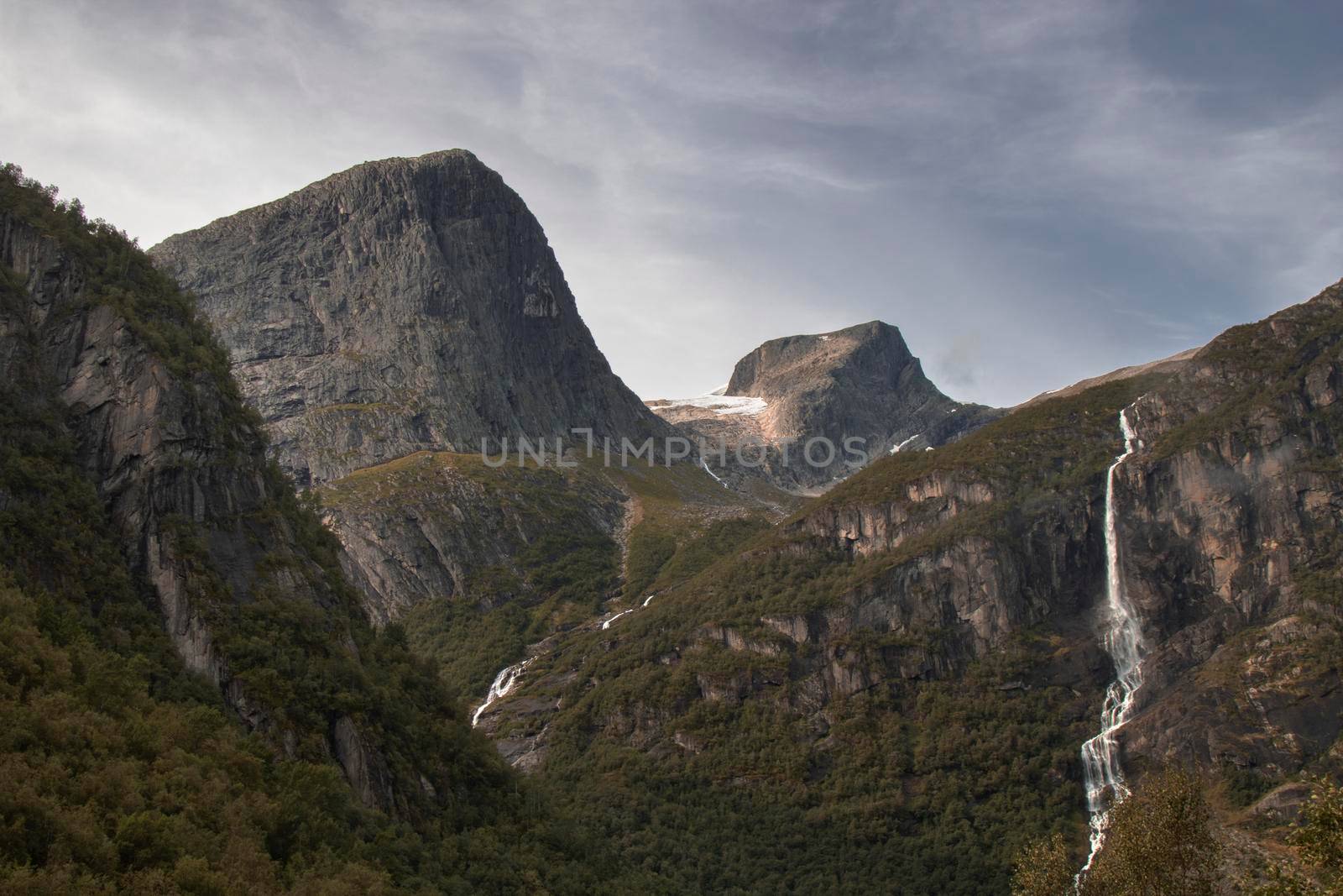 Landscape showing some peaks and a thin waterfall in Norway