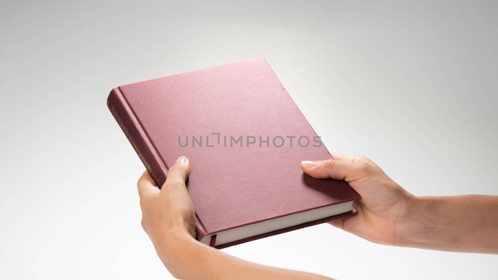 Women's hands holding a closed book, effect under a night lamp by voktybre