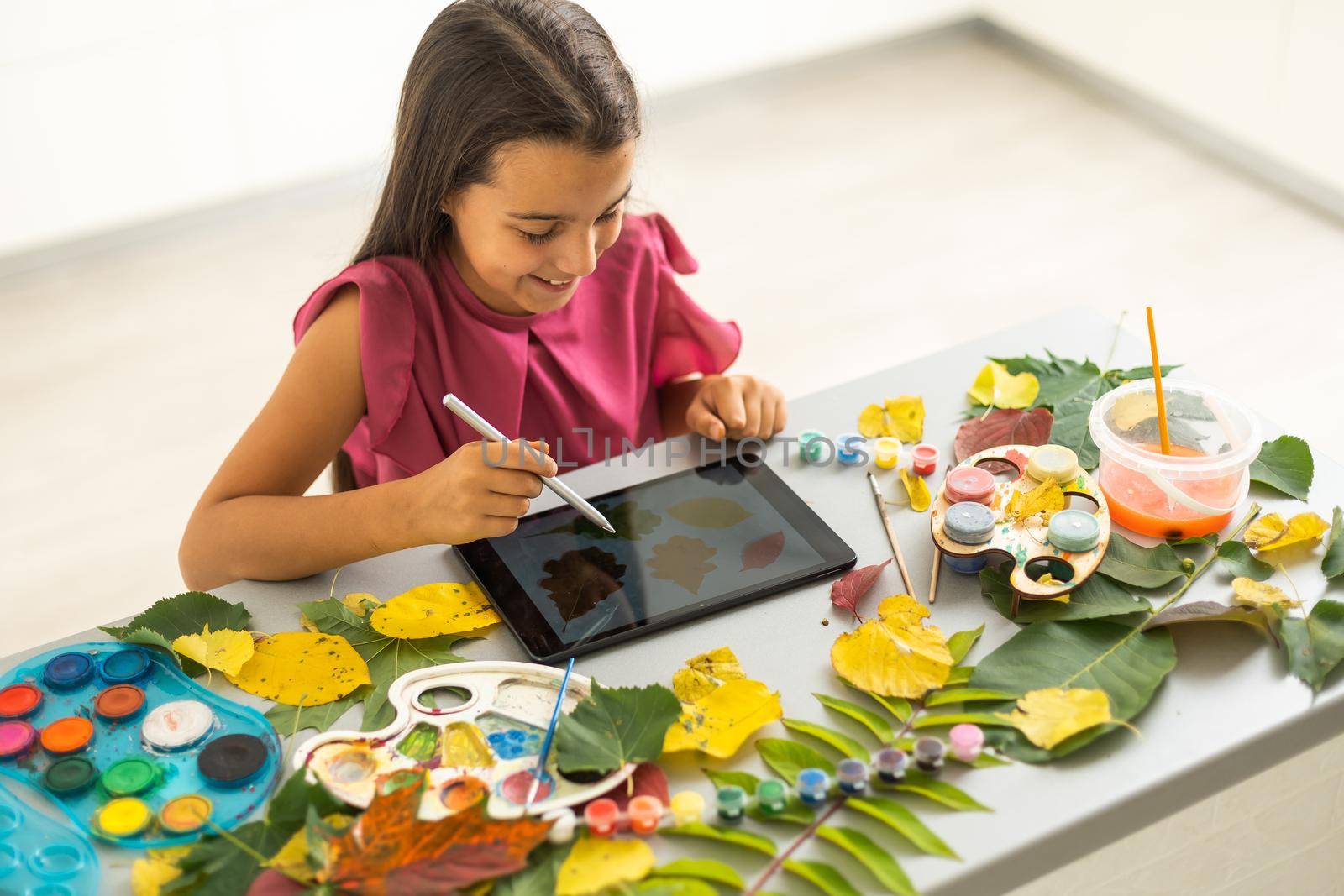 Notepad with watercolor paintings autumn leaves. View of workplace artist . High quality photo