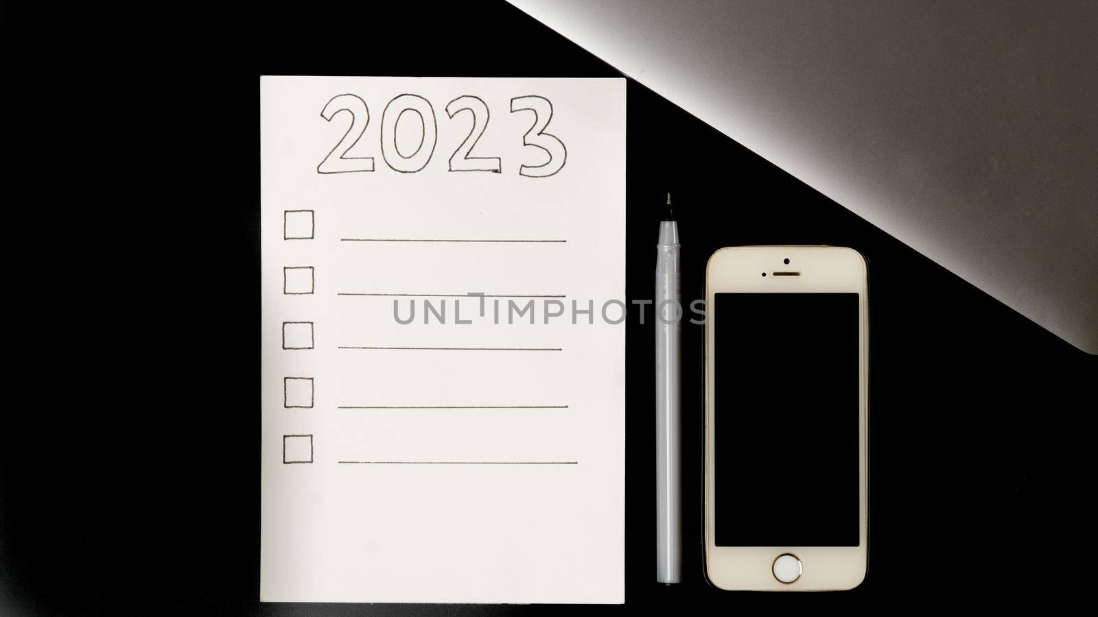 Checklist for the 2023 new year, make a plan on the desktop. High quality photo