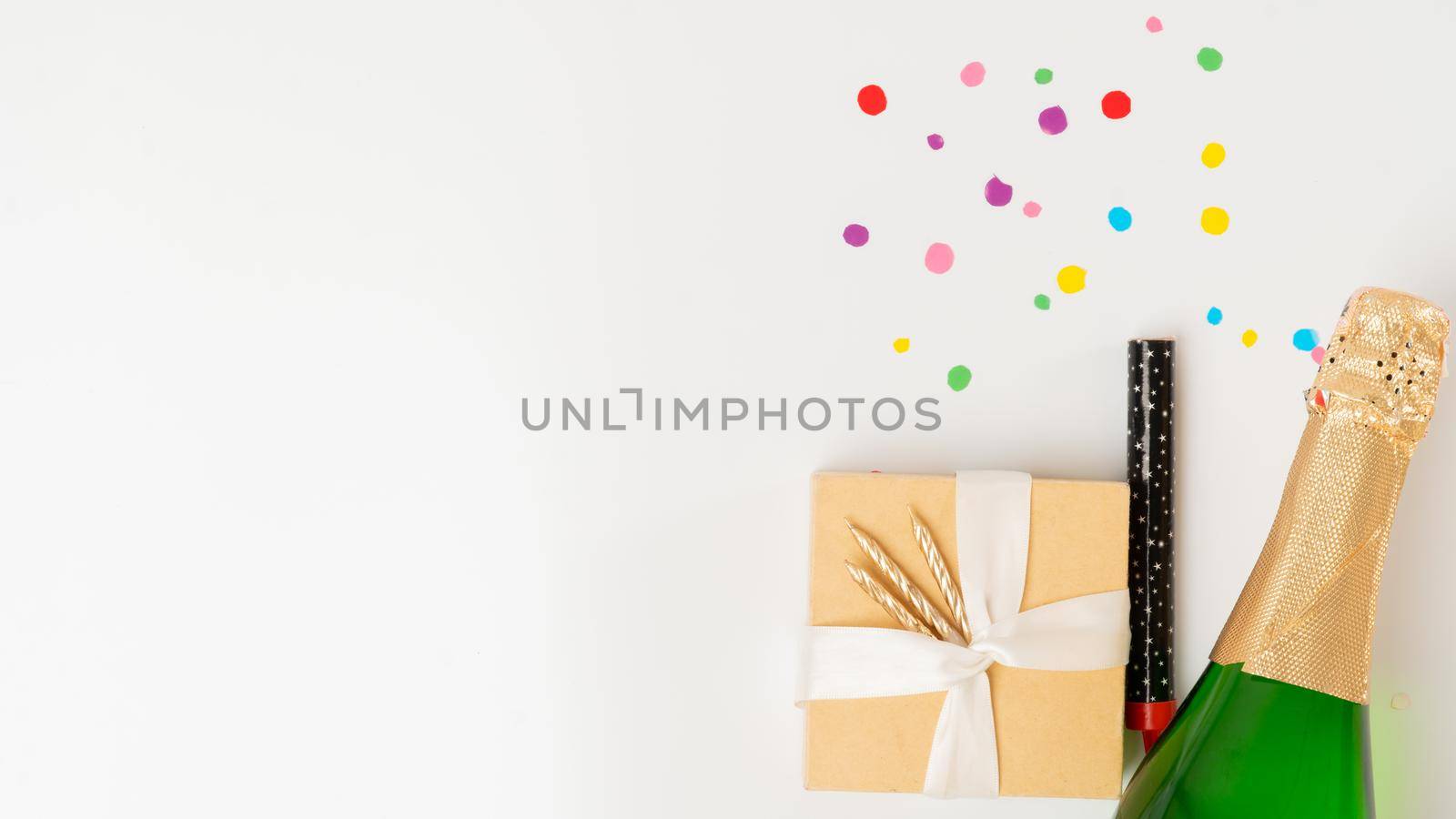 New Year's set - a gift, champagne and a cracker on a white background with a place for text. High quality photo