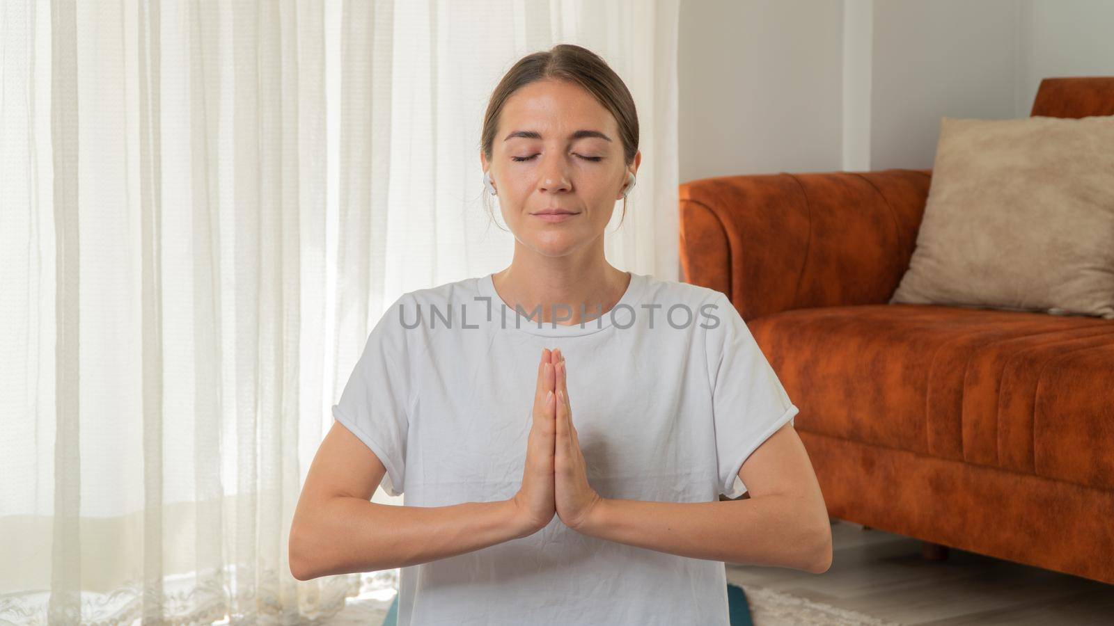 The girl meditates, hands folded in namaste. High quality photo
