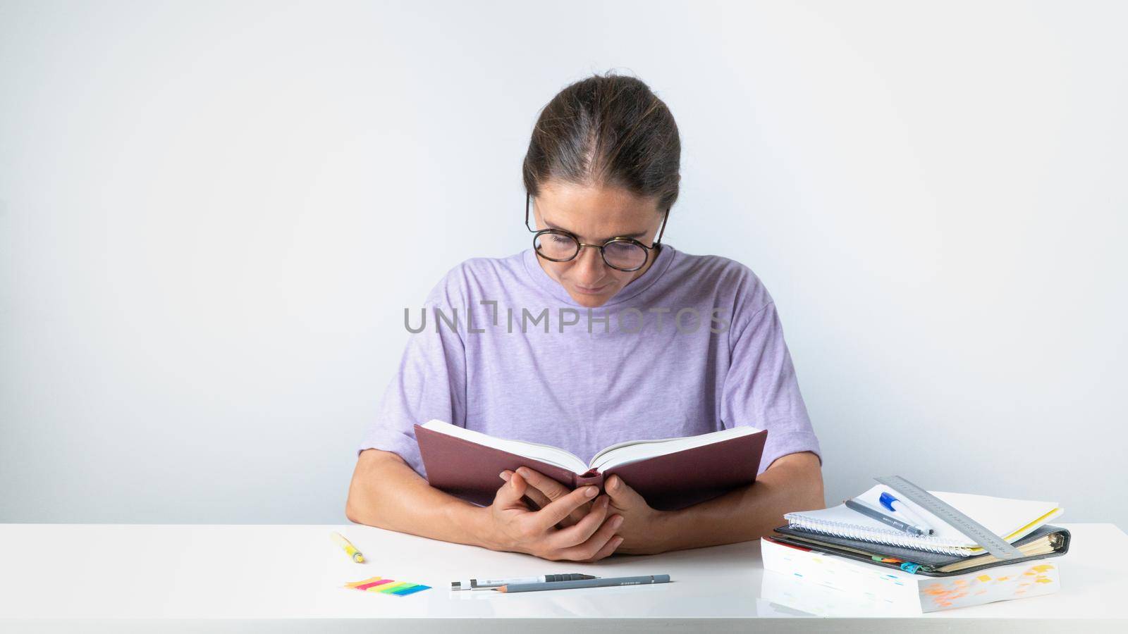 Student girl reading a book at the desk. High quality photo