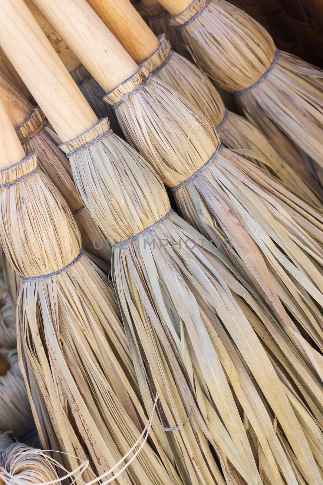 Small eco-friendly handmade brooms close up background