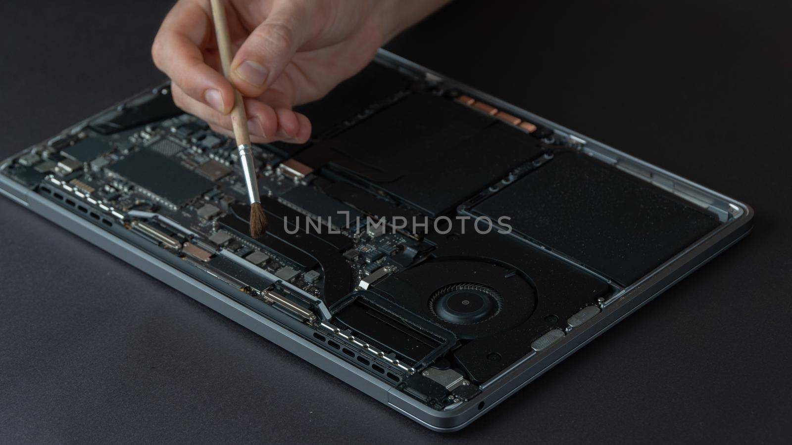 Removal of dust from the laptop, repair and maintenance of computer equipment. High quality photo