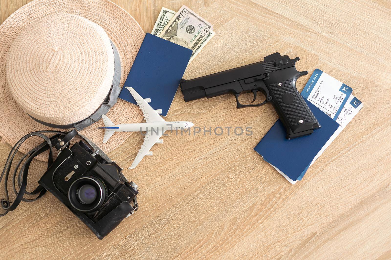 Travel and vacation concept, passport, money and gun on wood top table