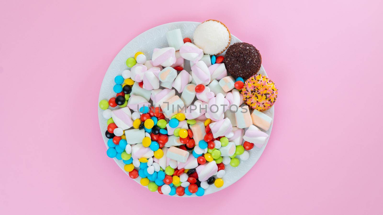 Sweet treat on a plate on a pink background with space for inscription. High quality photo