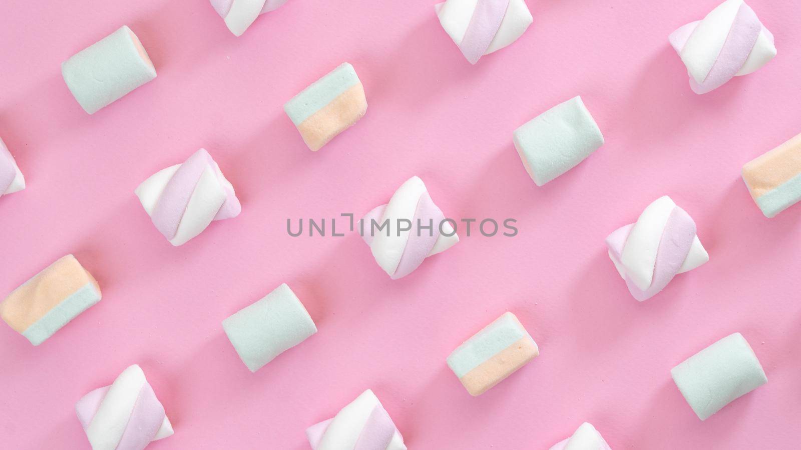 Multicolored marshmallows on a pink background, screensaver, collage by voktybre