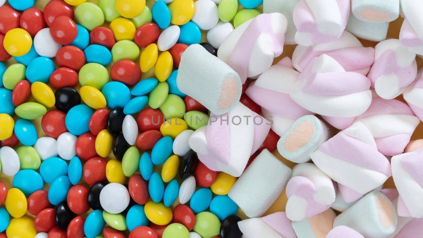 Background of marshmallows and colorful dragees, sweets by voktybre