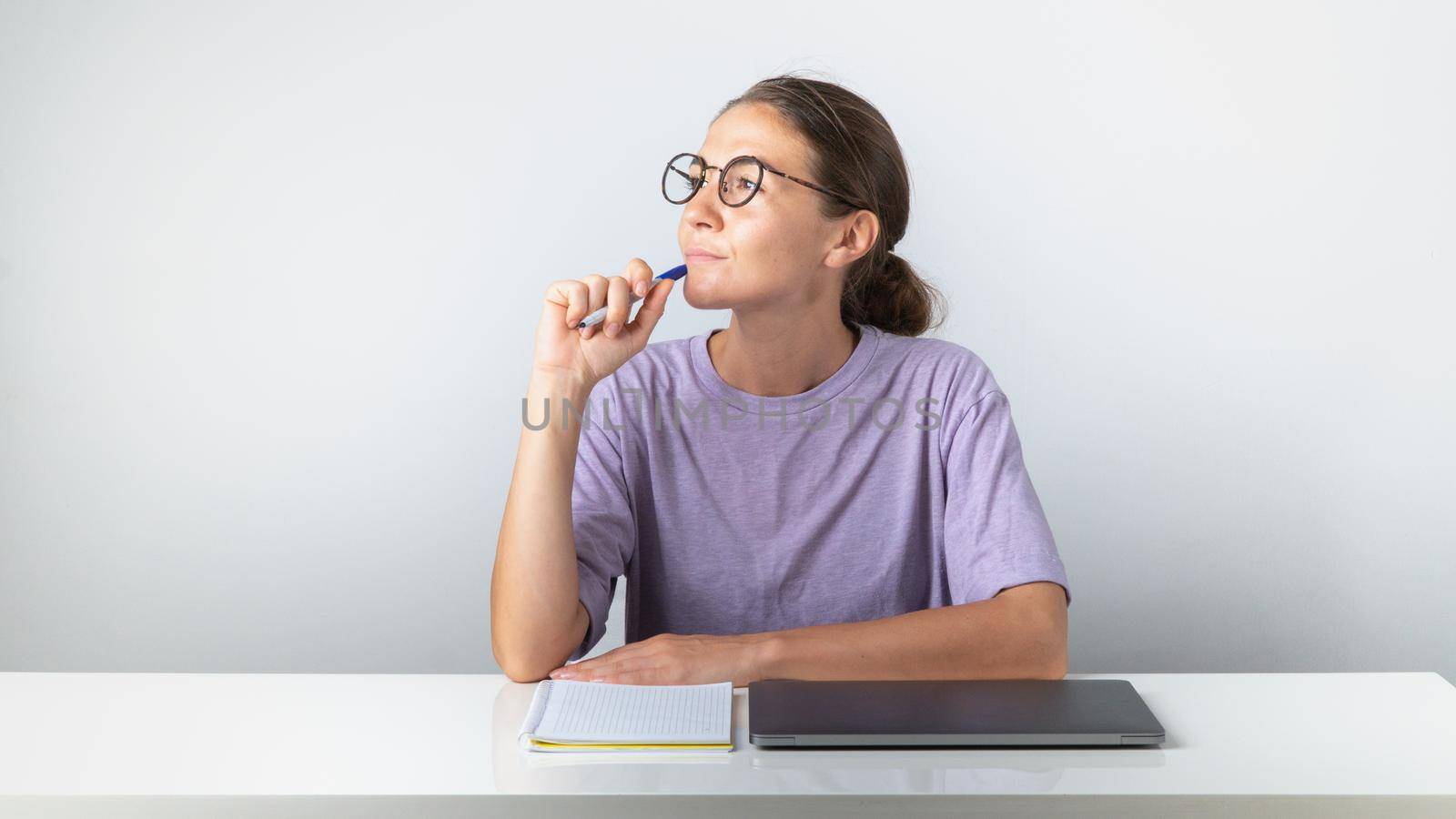 Student with laptop and notebook with a pensive look. High quality photo