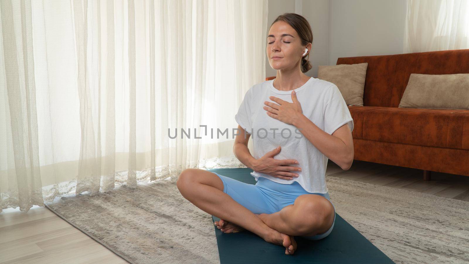 Breathing practice from yoga - a woman breathes and meditates. High quality photo