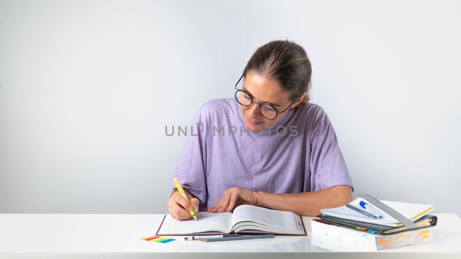 Student highlights the highlighter in the textbook during training. High quality photo