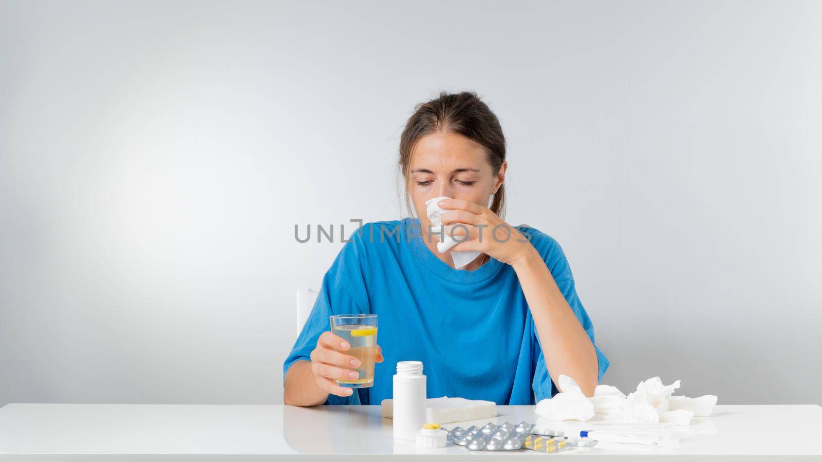 A woman with a runny nose and a cold - treatment for flu at home by voktybre