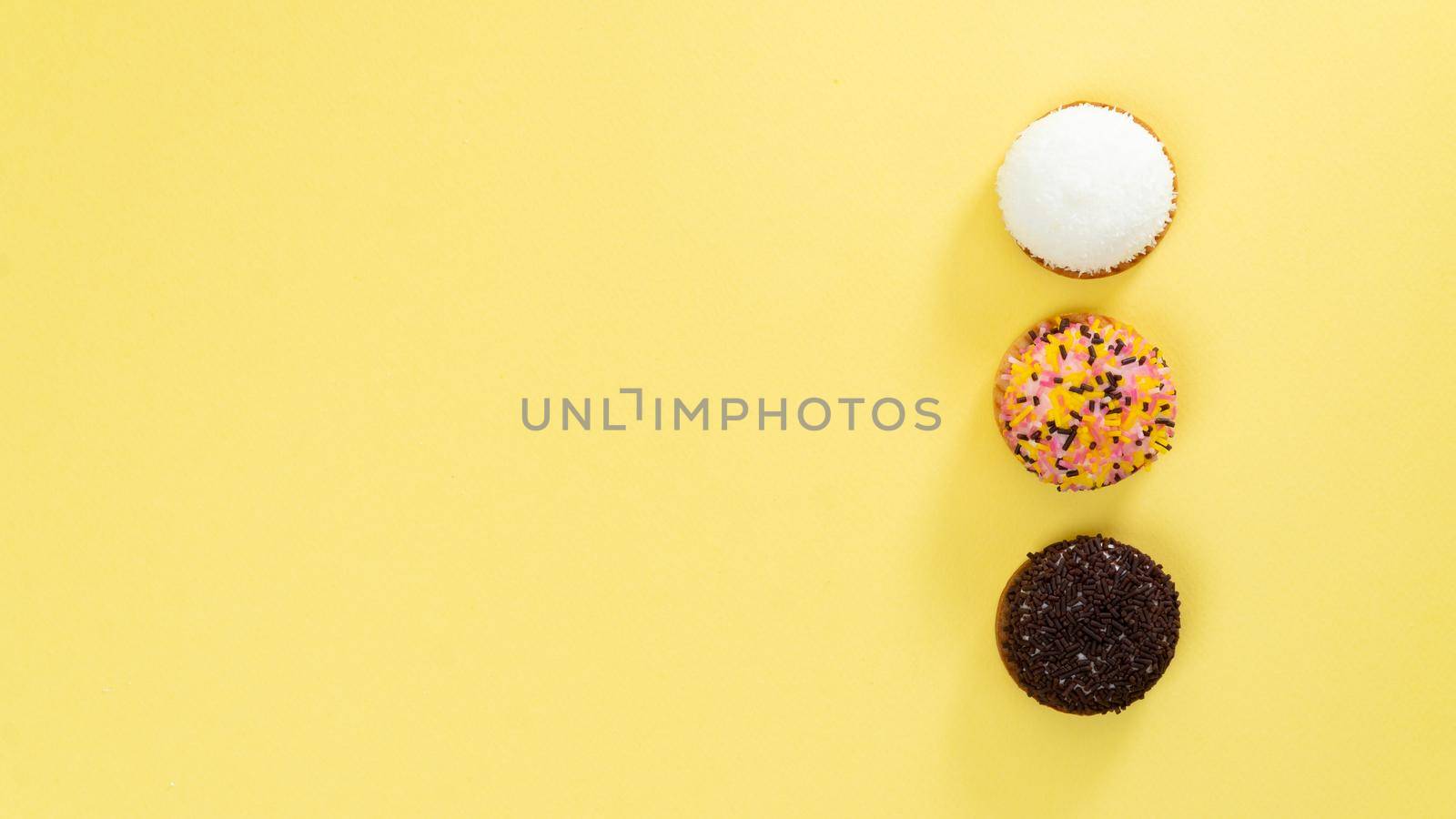 Cakes on a yellow background - sweet food, background with space for inscription. High quality photo