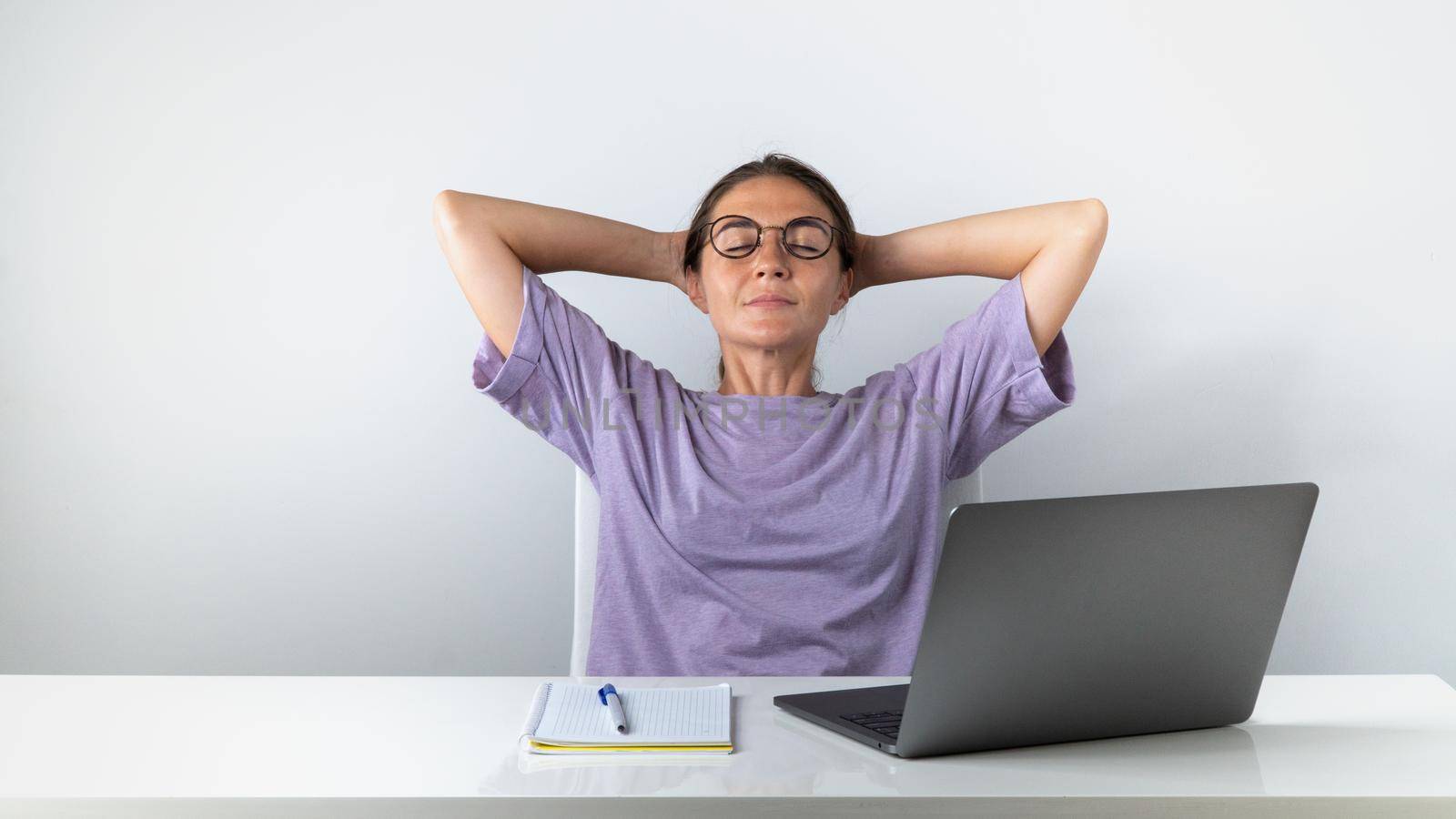 Girl student finished online learning relaxing on a chair by voktybre