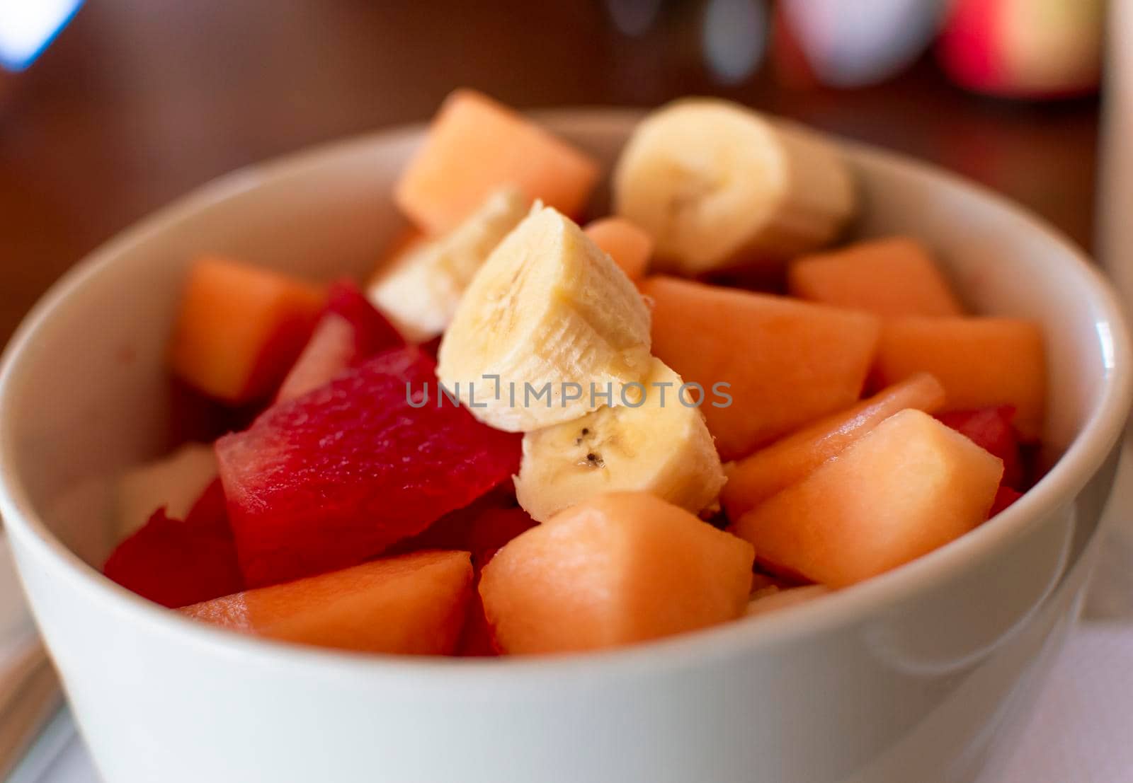 Close up of a cup of banana fruit salad with watermelon, Close up of fruit salad of banana, watermelon and melon