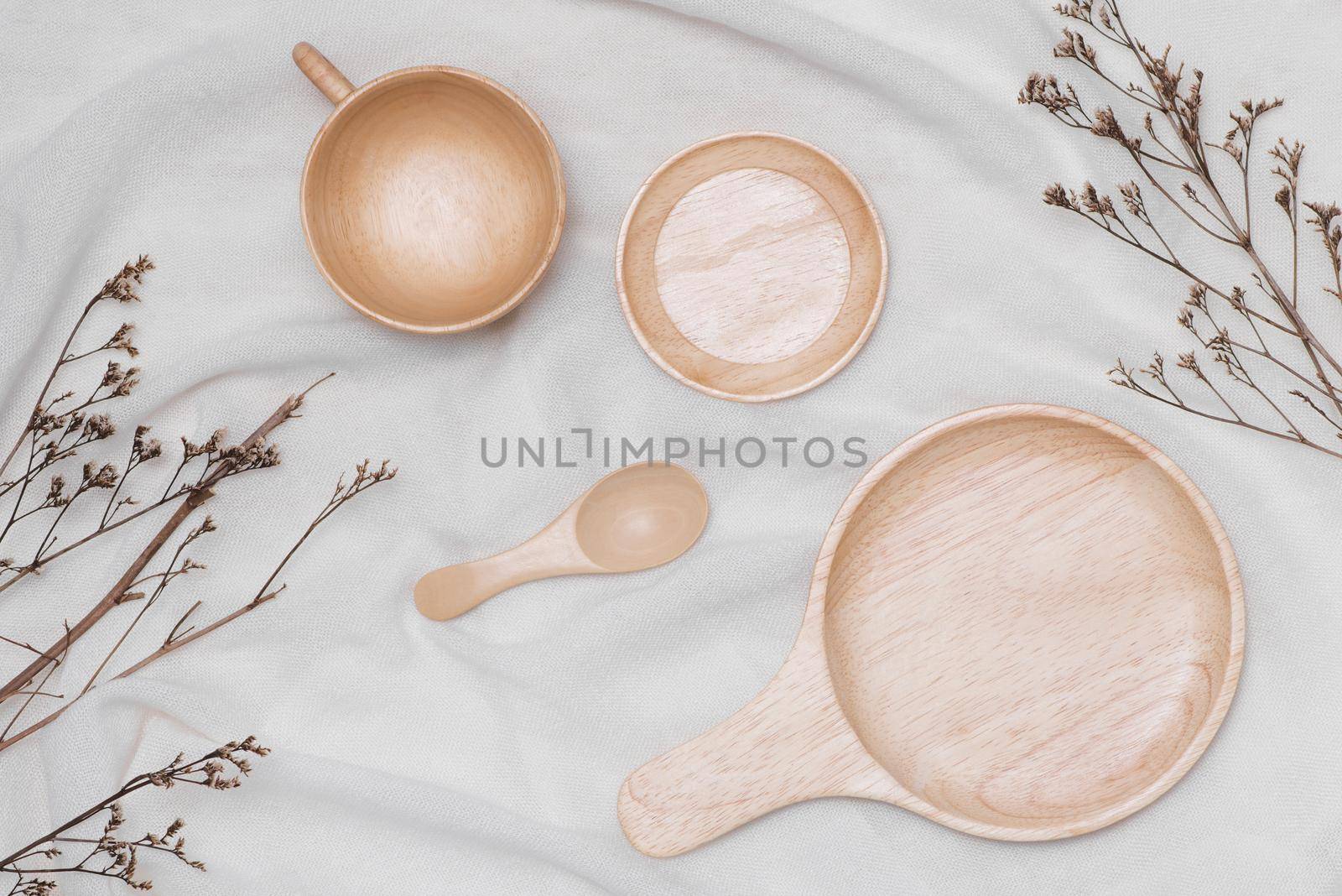 Different wooden kitchenware on wooden table, close up by makidotvn