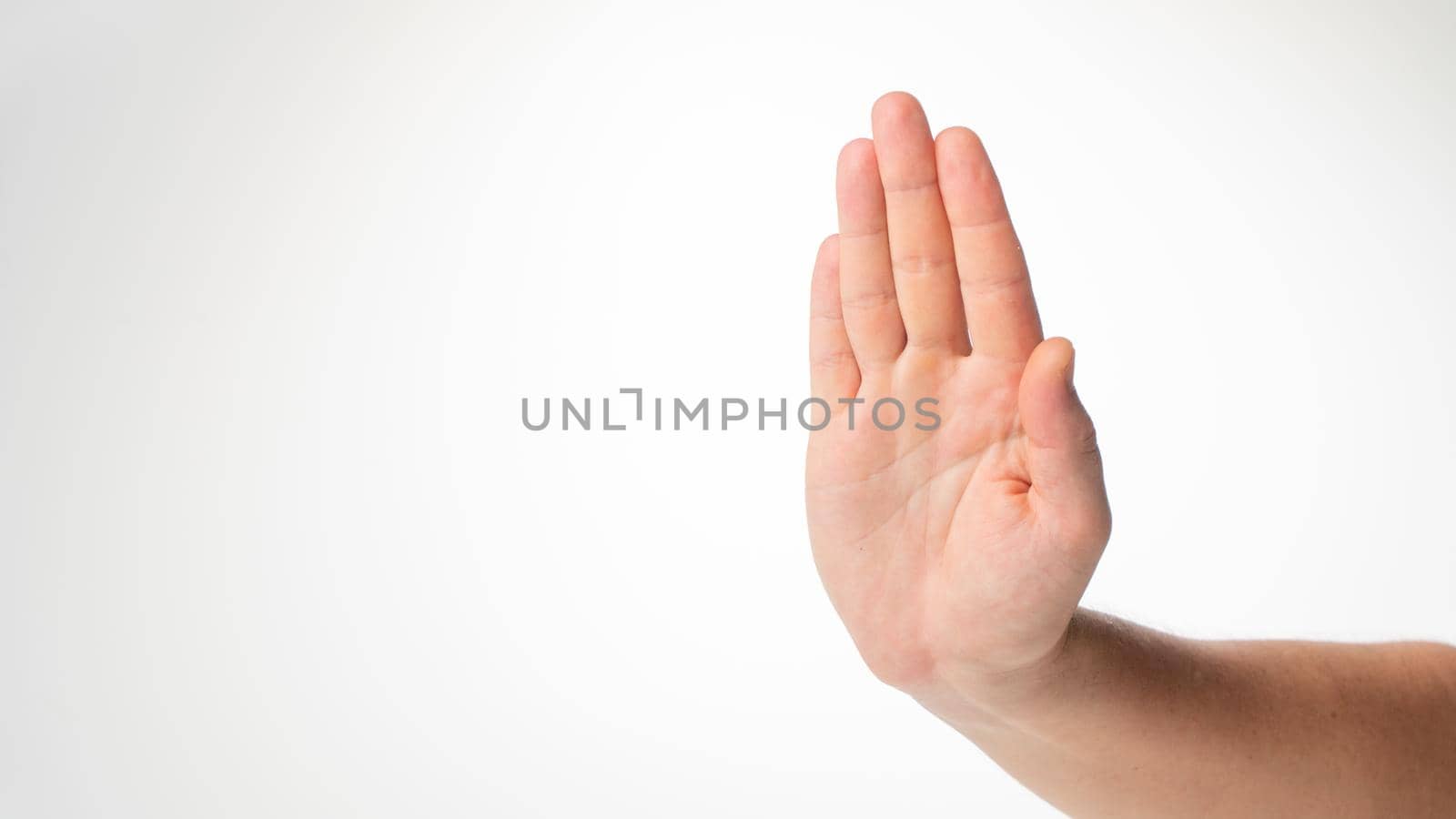 Men's hand gesture stop on a white background. High quality photo