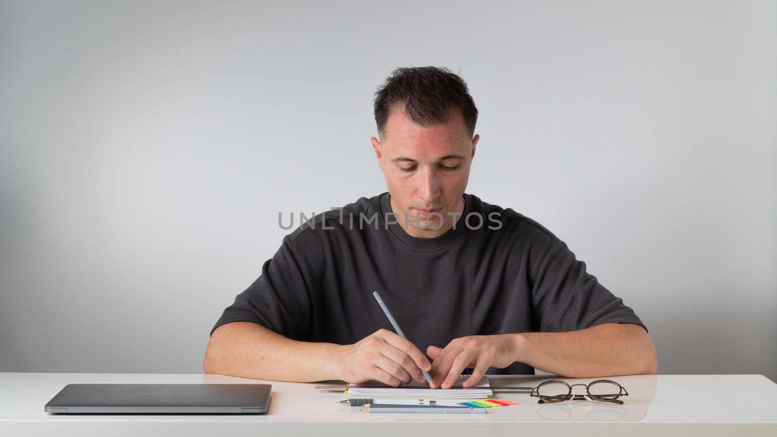 The guy at the desk draws with a ruler with a pencil - study, work. High quality photo